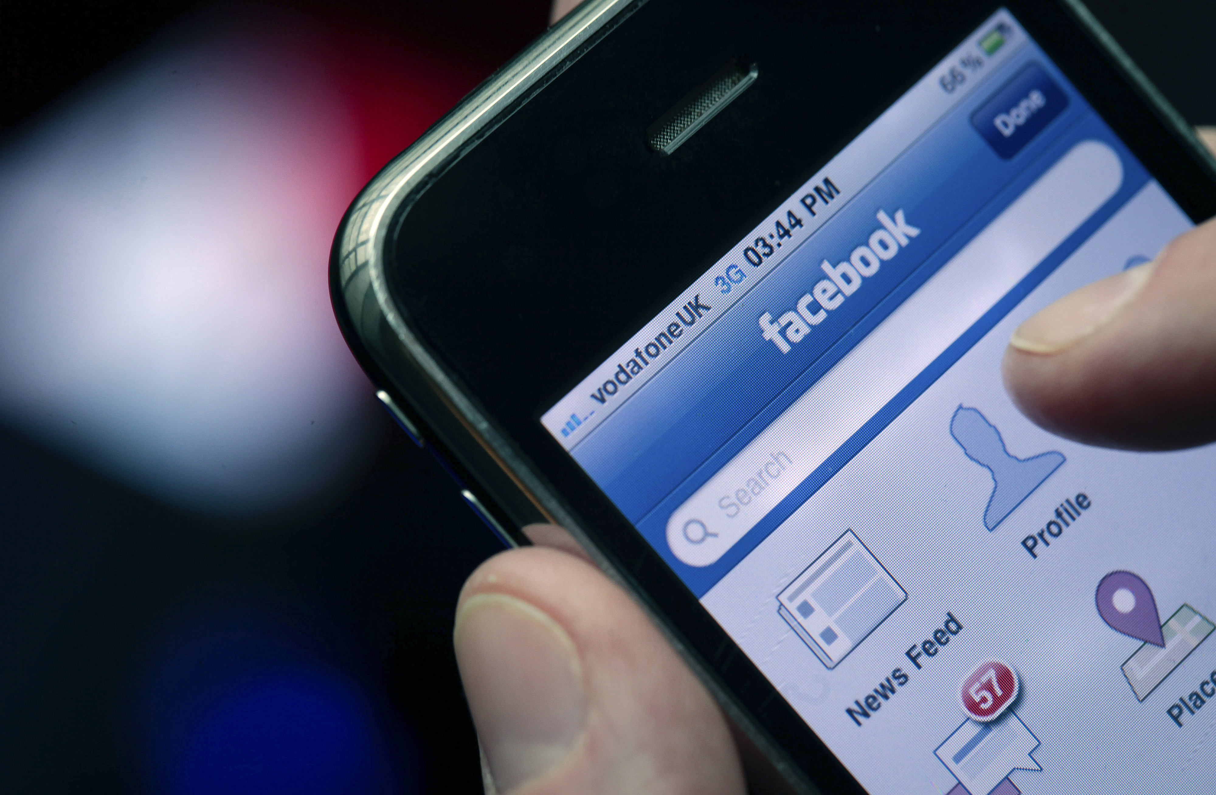 The Facebook Inc. logo is seen on an Apple Inc. iPhone in this arranged photograph in London, U.K., on Monday, May 14, 2012. Facebook Inc. plans to stop taking orders for its initial public offering tomorrow, two days ahead of schedule, according to a person with knowledge of the transaction. Photographer: Jason Alden/Bloomberg via Getty Images