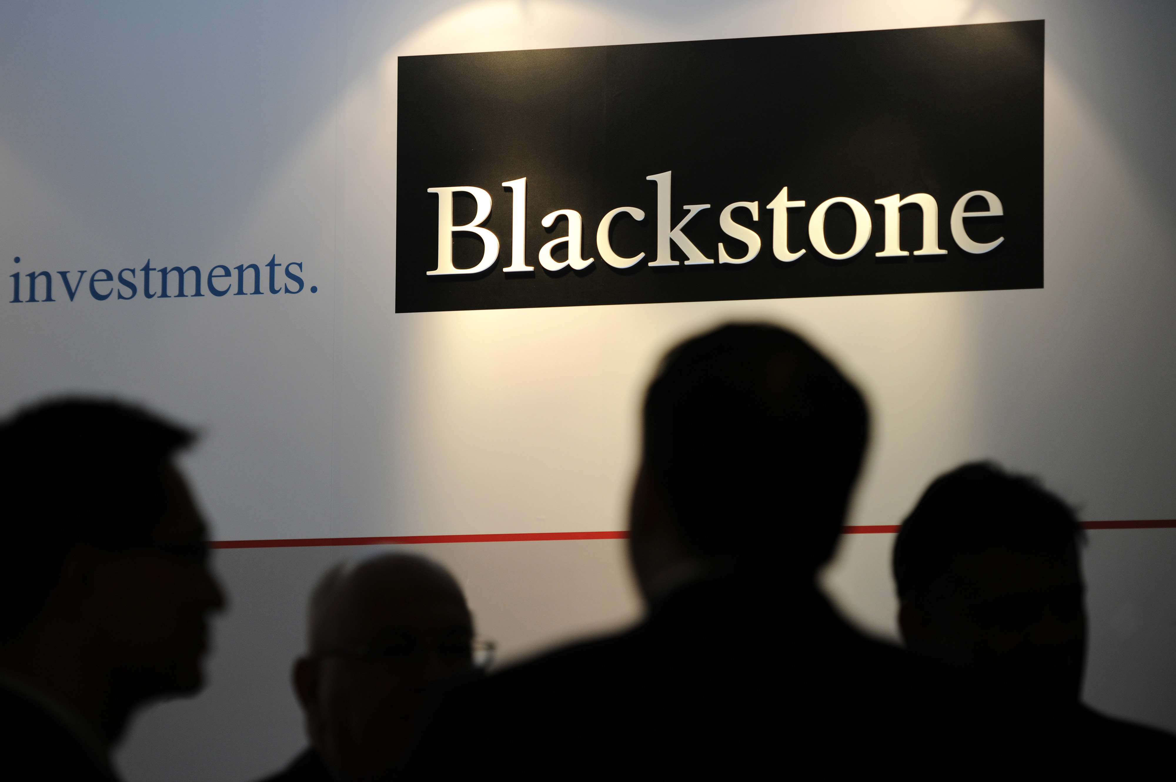 The logo for Blackstone Group LP is displayed during the opening of the company's new office in Singapore, on Monday, Oct. 21, 2013. Blackstone, the world's biggest manager of alternative assets such as private equity and real estate, last week reported that third- quarter profit rose 3 percent as gains in property holdings offset a decline in its buyout unit. Photographer: Munshi Ahmed/Bloomberg *** Local Caption *** Stephen Schwarzman