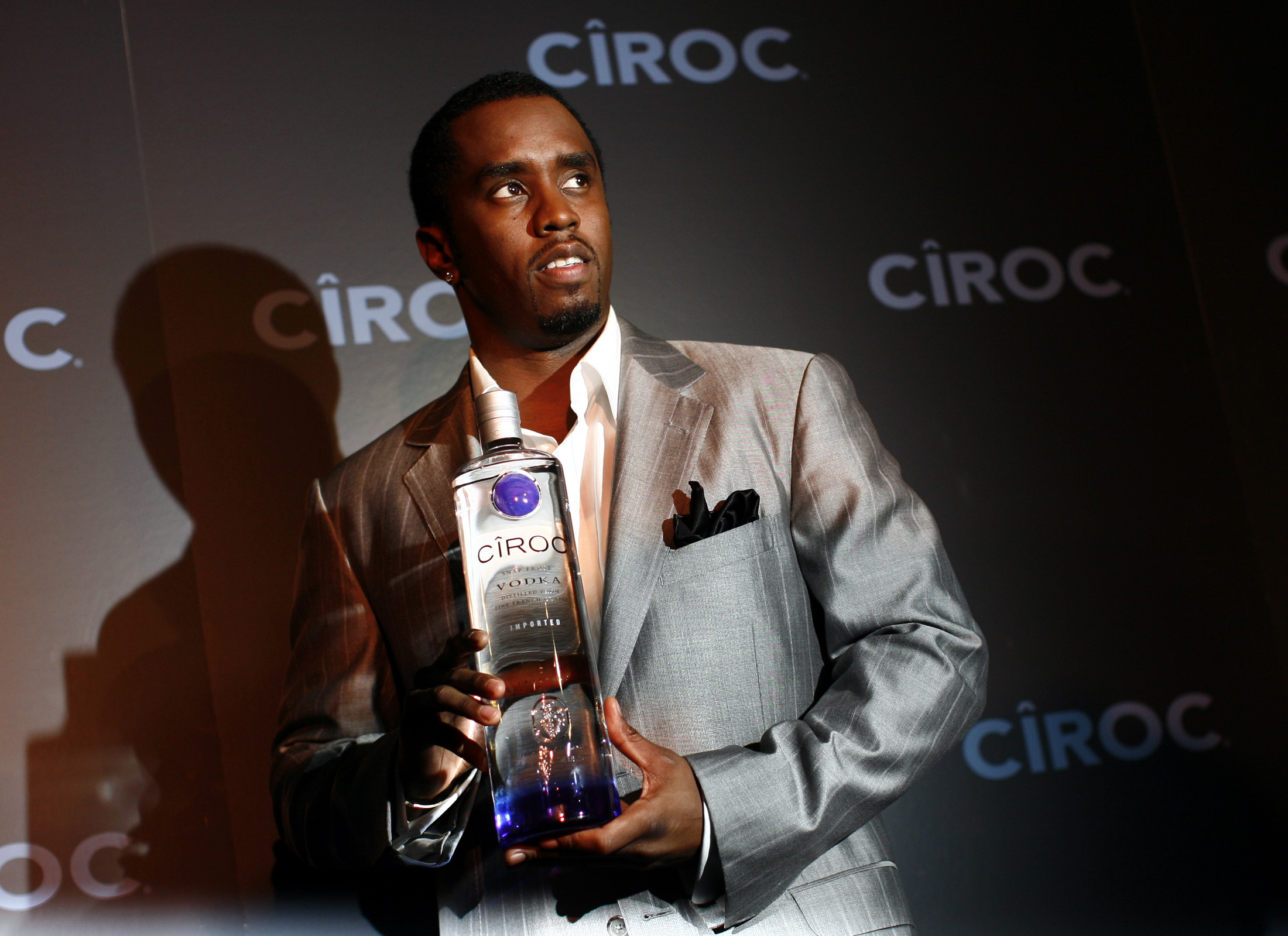 Sean "Diddy" Combs poses with a bottle of Ciroc vodka before a press conference announcing his alliance with the Diageo spirits company in New York