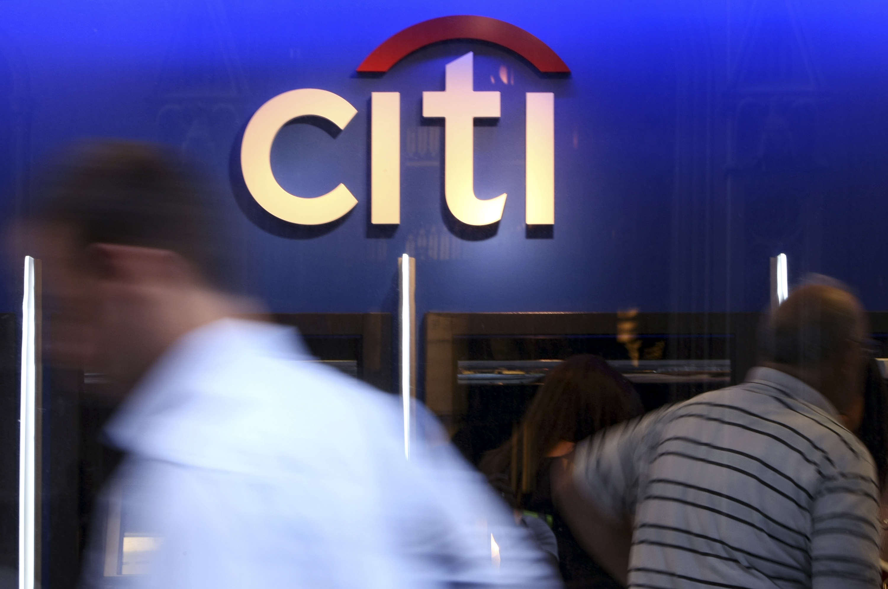 Pedestrians pass a Citigroup Inc. bank branch in New York.