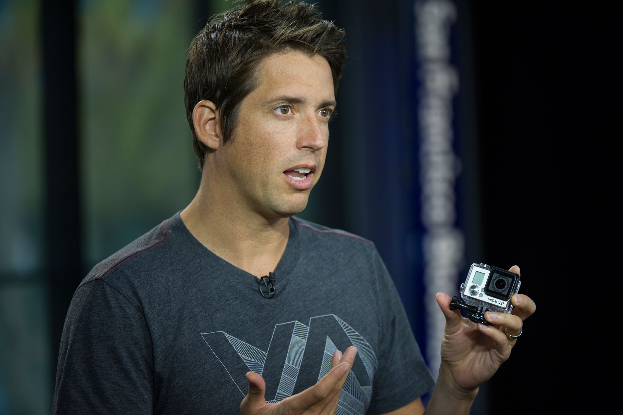 Nicholas "Nick" Woodman, founder and chief executive officer of GoPro, holds a GoPro Hero 3+ camera.