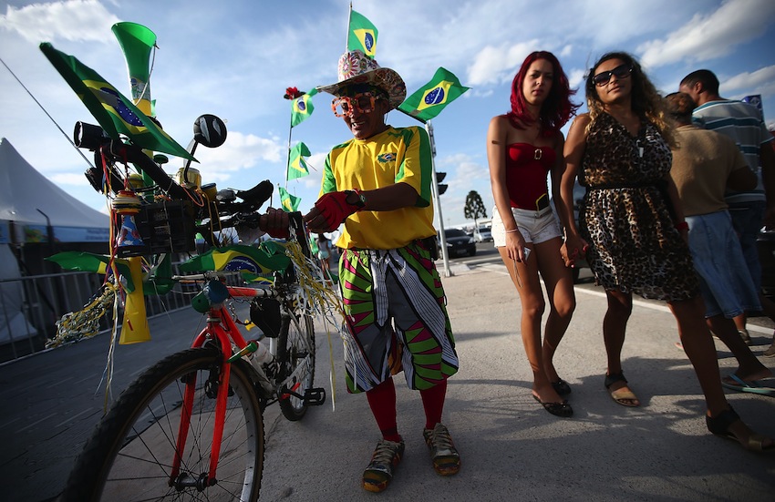 A Brazil fans stands outside of opening ceremony rehearsals around Itaquerao stadium