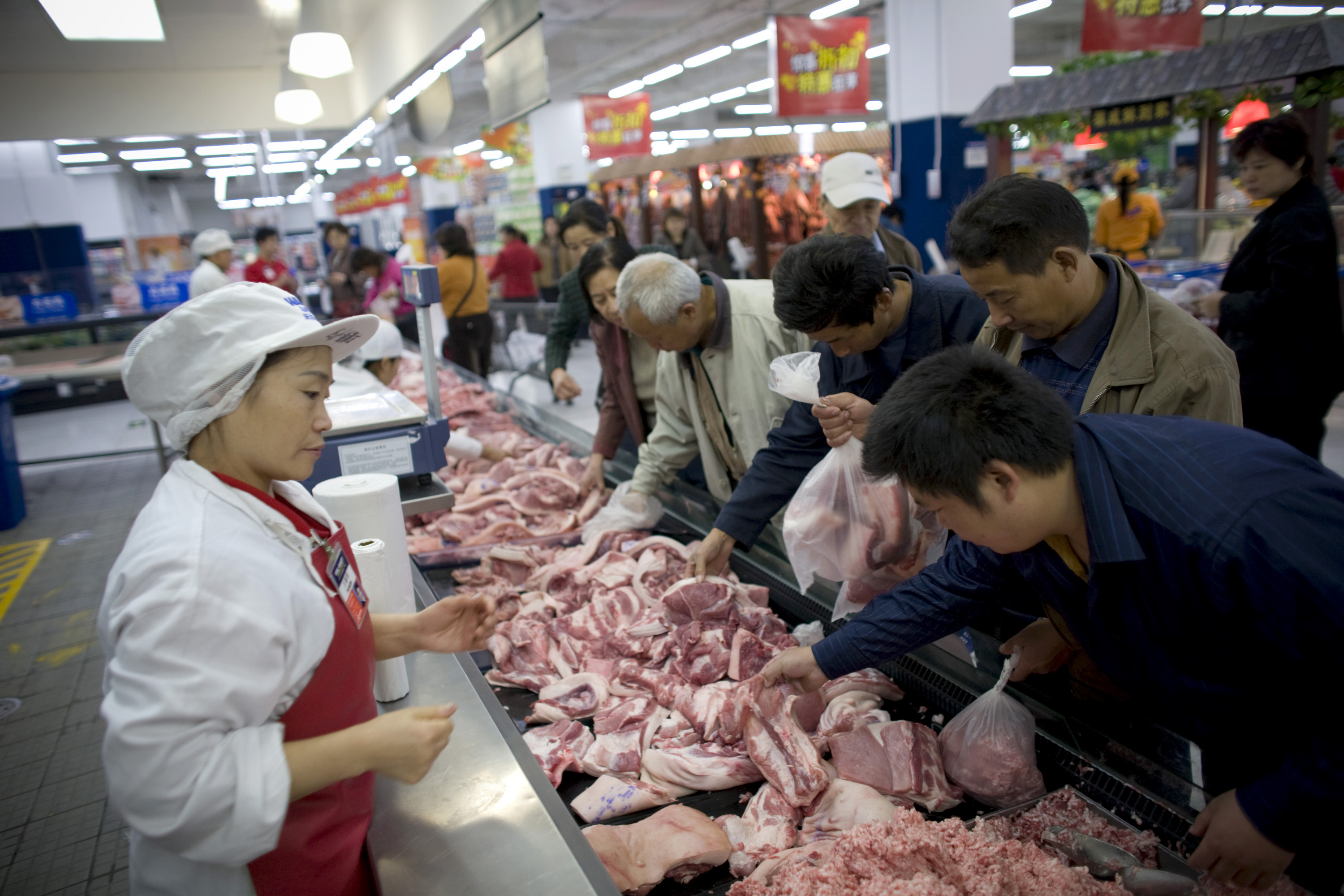 Customers select meat at a Wal-Mart Stores Inc. outlet in Be