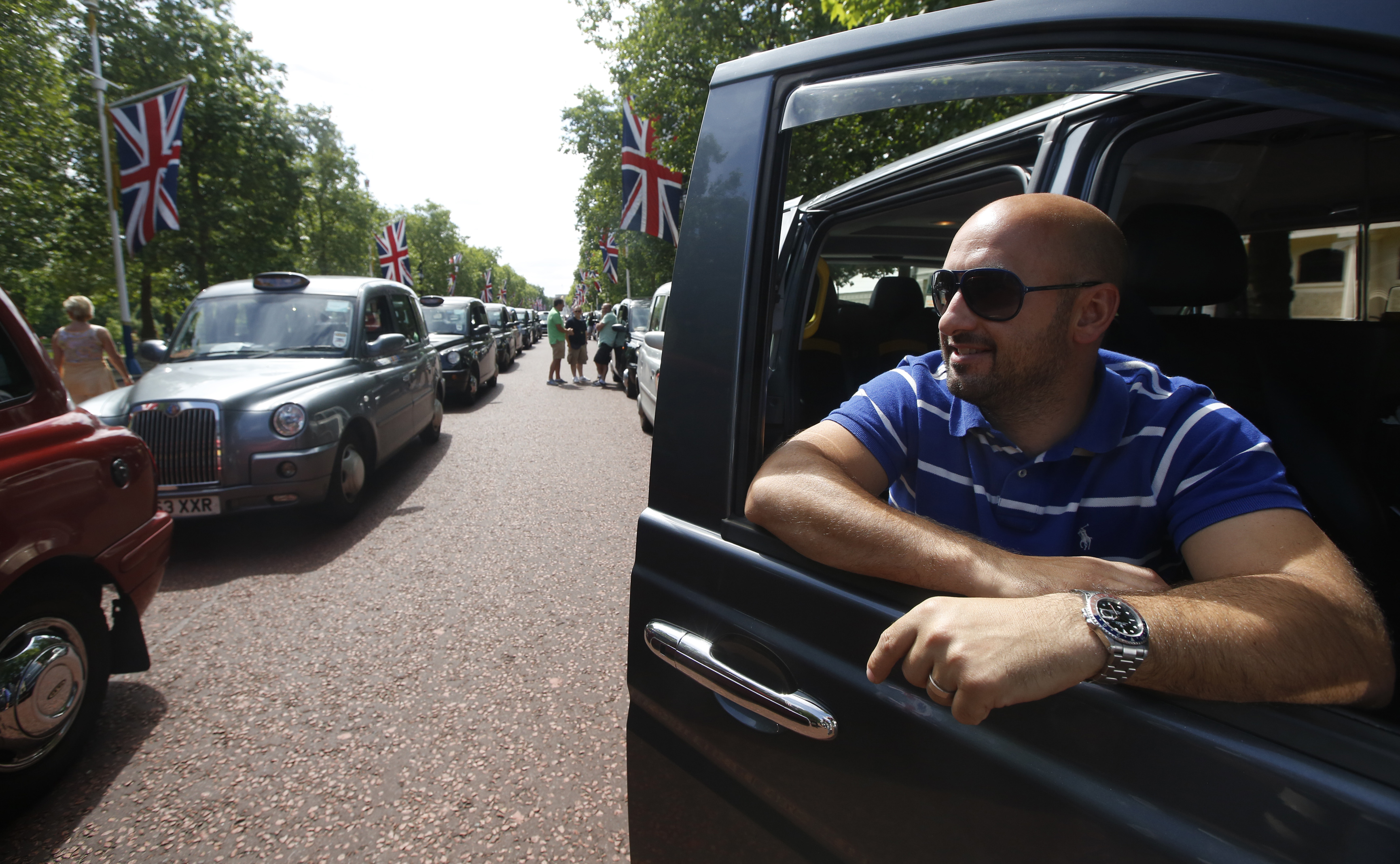 Taxi driver Joe Senatore joins other drivers during a demonstration along the Mall in central London