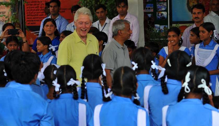 Bill Clinton speaks with schoolchildren during a visit to Sanganer, India
