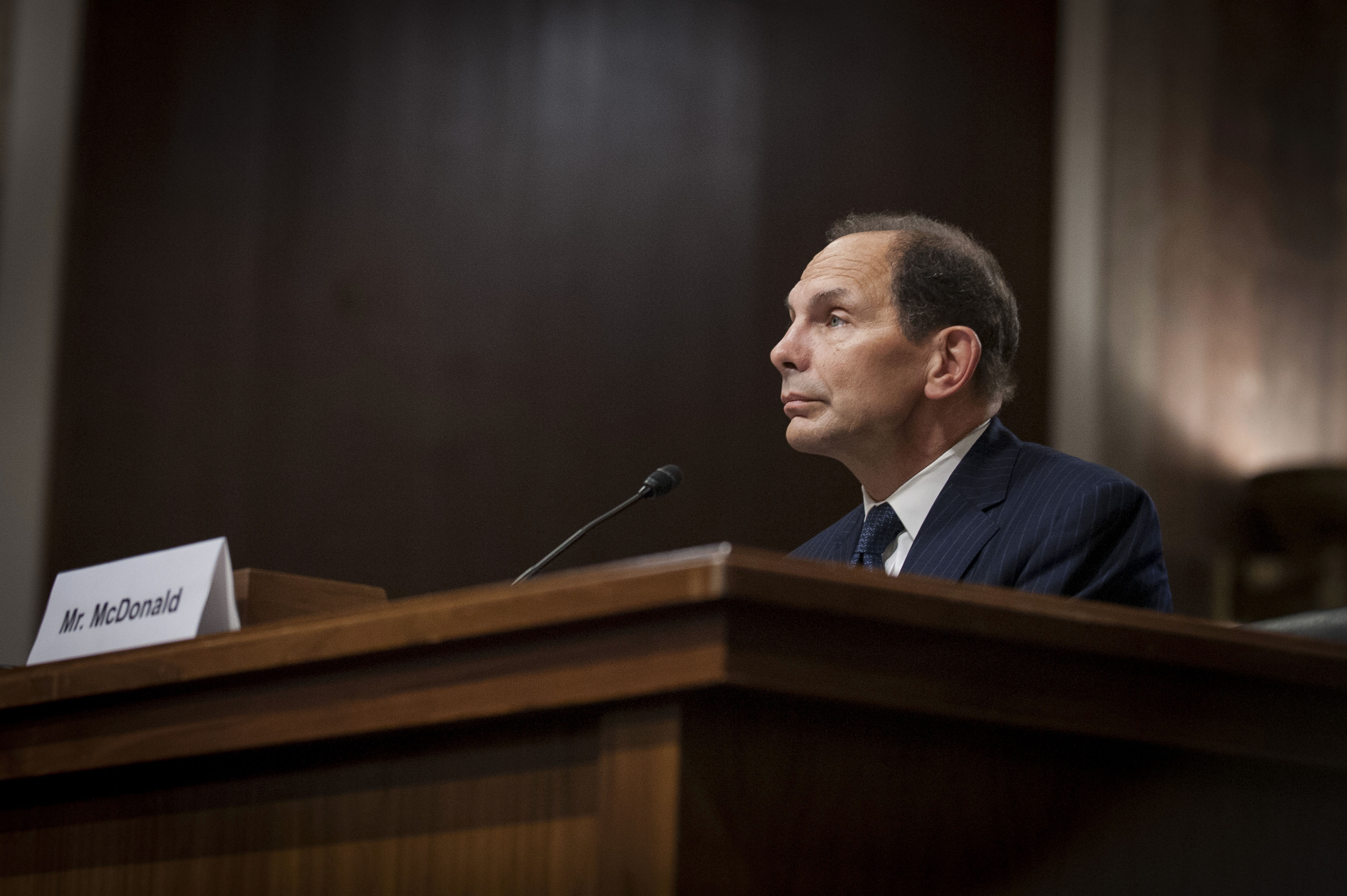 Caption:Robert 'Bob' McDonald, former chief executive officer of Procter &amp; Gamble Co., listens while testifying during a nomination hearing before the Senate Veterans Affairs Committee in Washington, D.C., U.S., on Tuesday, July 22, 2014. McDonald said he'd use the skills he developed during three decades in the private sector to overhaul the troubled U.S. Department of Veterans Affairs. Photographer: Pete Marovich/Bloomberg via Getty Images
