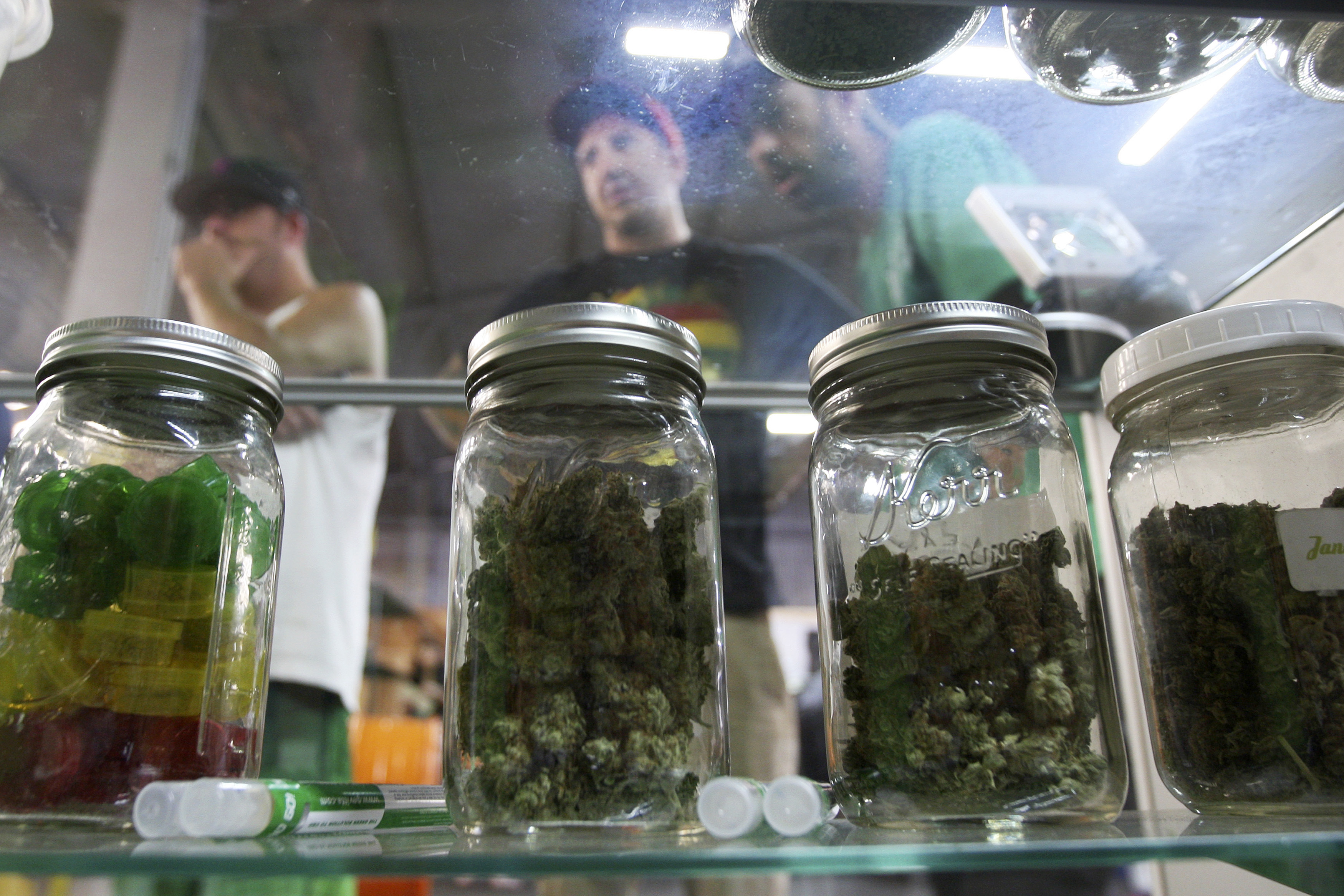 People look at jars of marijuana at the medical marijuana farmers market in Los Angeles