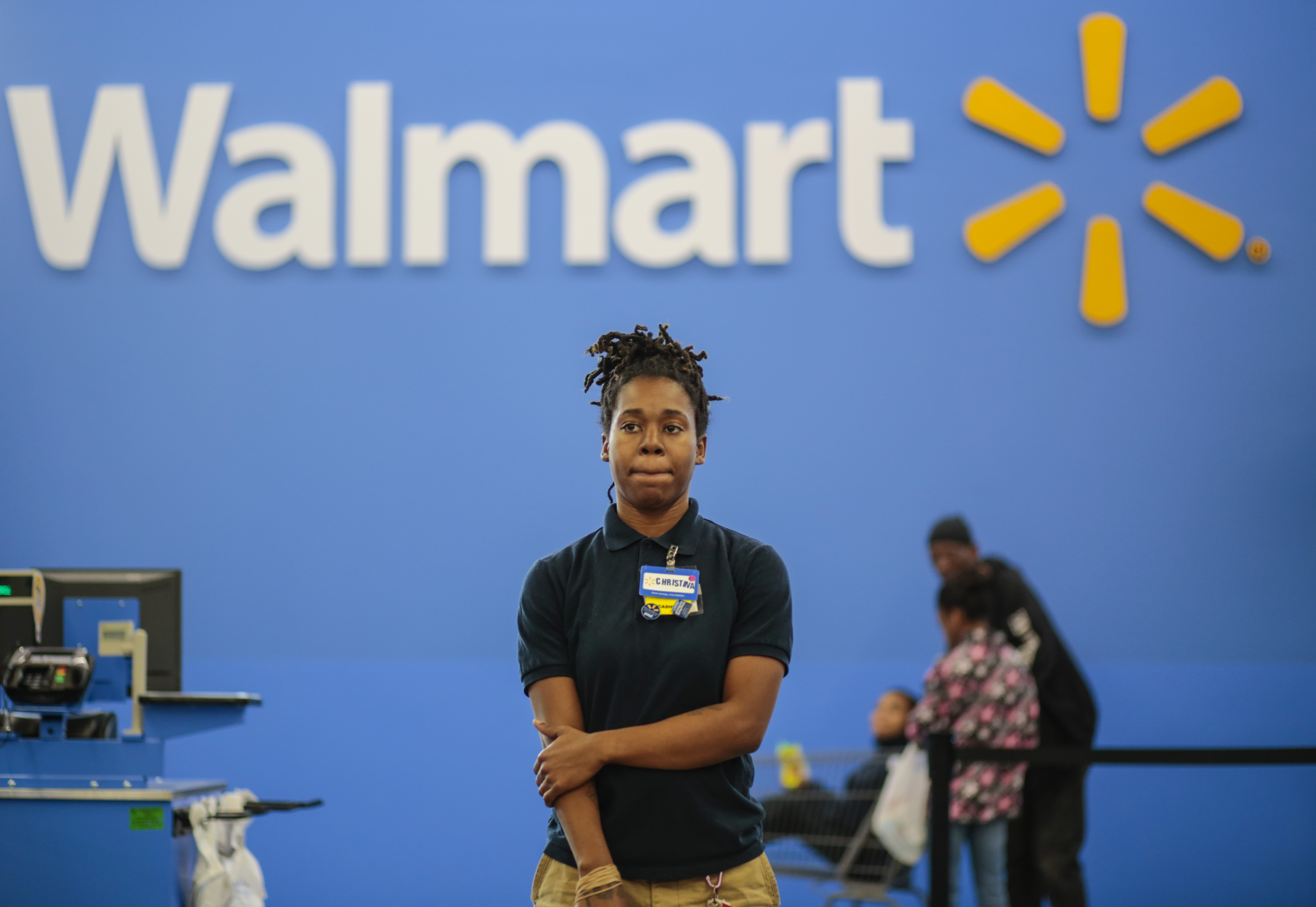 WASHINGTON, DC - DECEMBER, 21: Christina Ford, stands by to help customers at the self checkout registers at a new Wal-Mart in Washington, DC, Saturday December 21, 2013. Ford, who was laid off from her job working at a group home for the elderly and was out of work for more than a year and living in a homeless shelter with her children, was hired by Wal-Mart in October. (Photo by Dayna Smith/For The Washington Post via Getty Images)