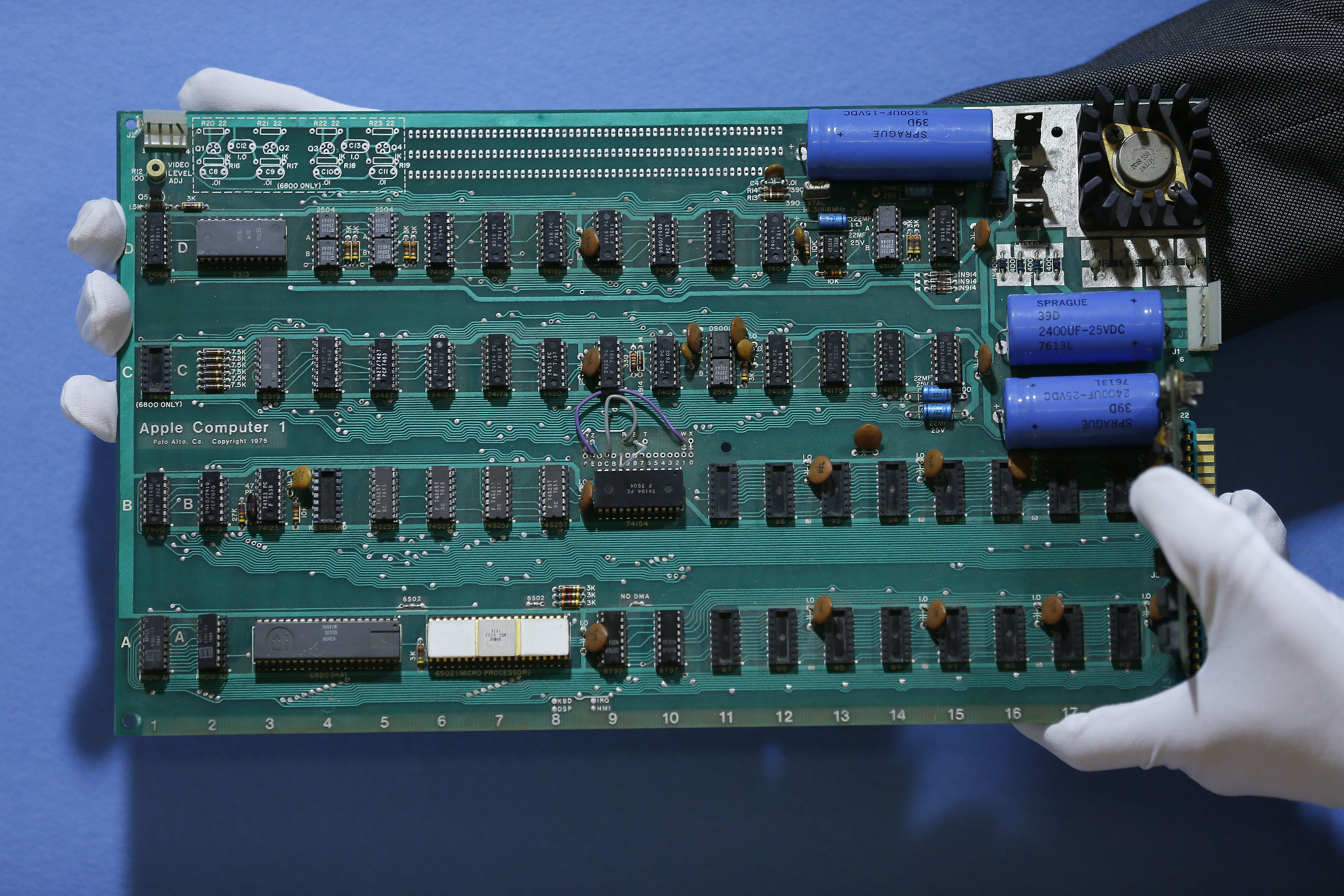A employee holds an Apple-1 personal computer, serial number 22, owned by the estate of Joe Copson ahead of its sale at Christie's in London