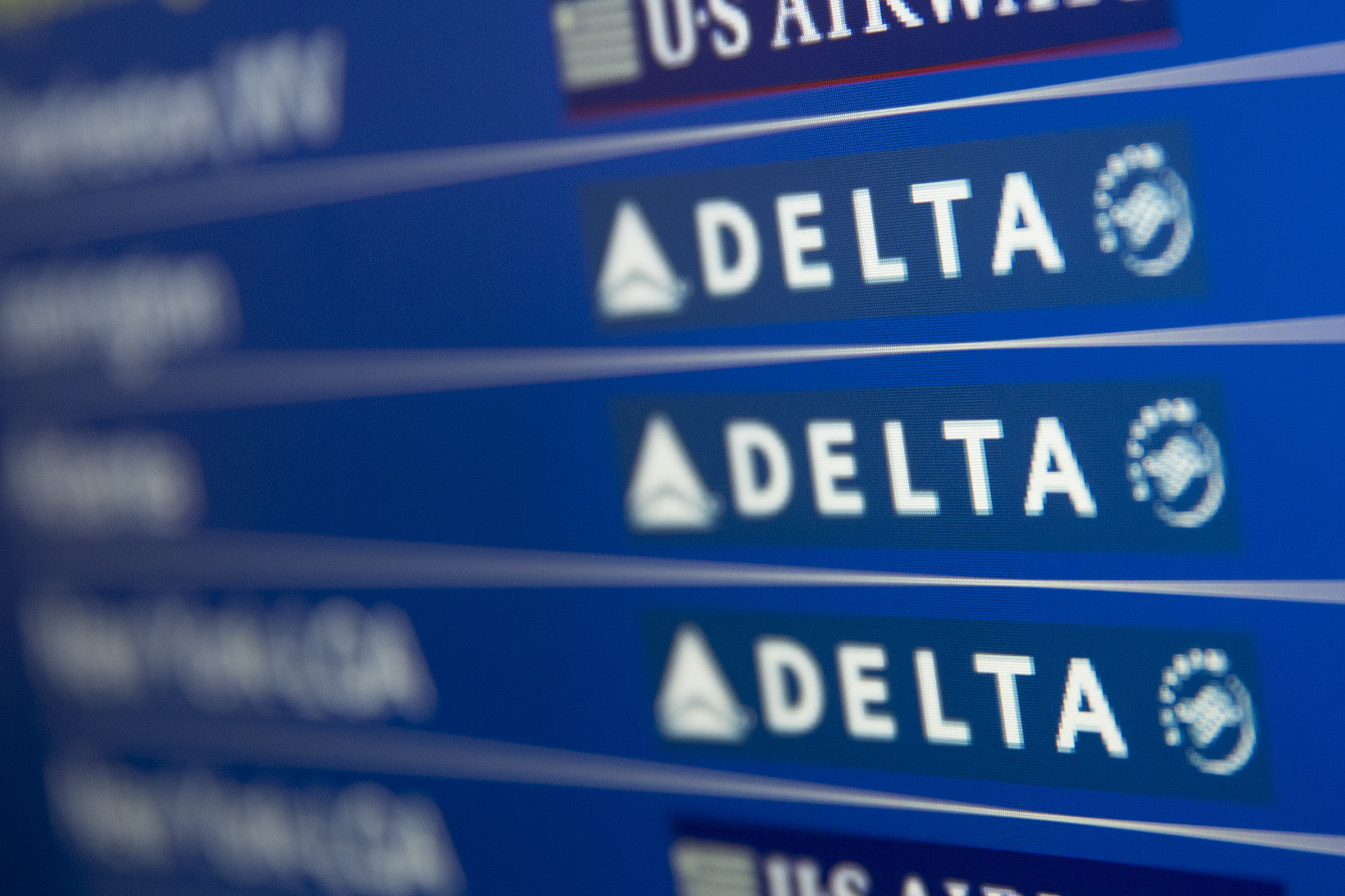 The Delta Air Lines Inc. logo is seen on the departures and arrivals screen at Ronald Reagan National Airport in Washington, D.C., U.S., on Friday, July 18, 2014. Delta Air Lines Inc., the third-largest U.S. airline, is expected to report second quarter earnings figures on July 23. Photographer: Andrew Harrer/Bloomberg via Getty Images