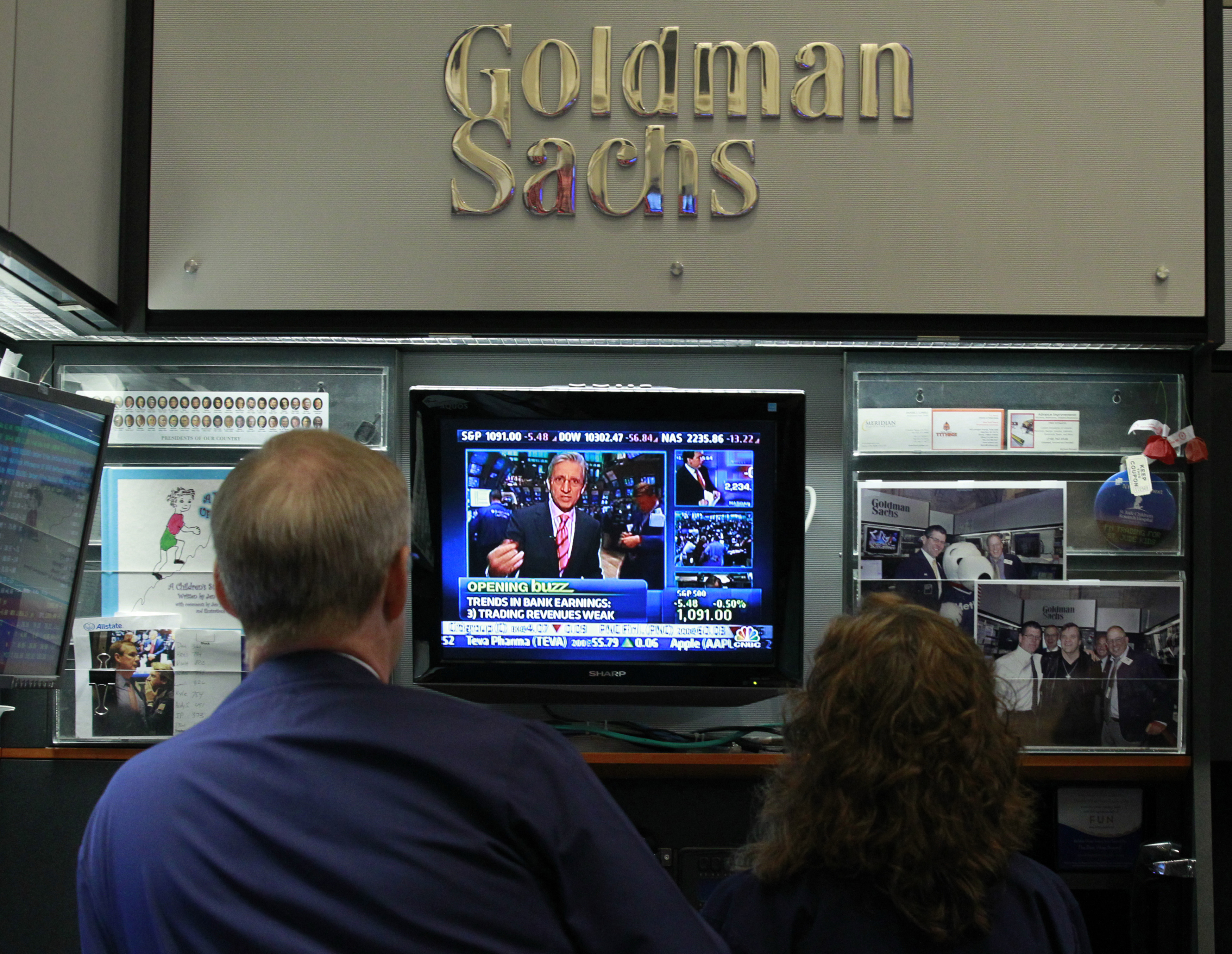 Traders work in the Goldman Sachs stall on the floor of the New York Stock Exchange