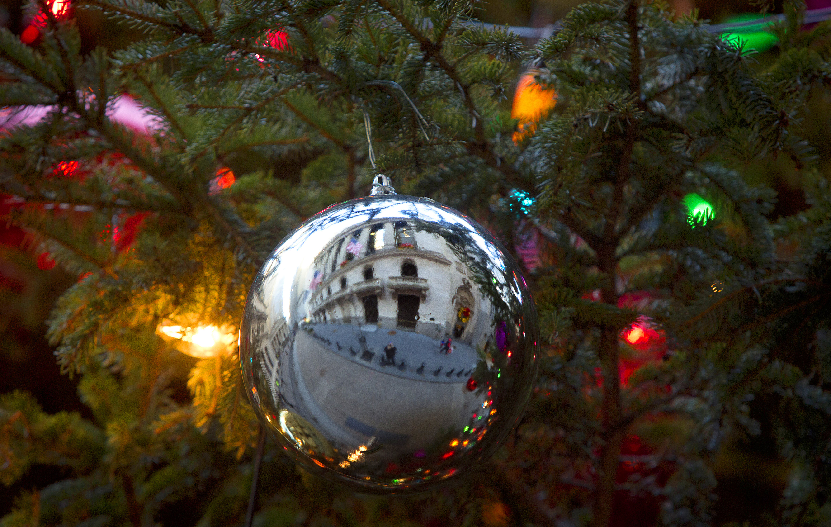 The New York Stock Exchange is pictured reflected in a Christmas Ornament in a tree in New York