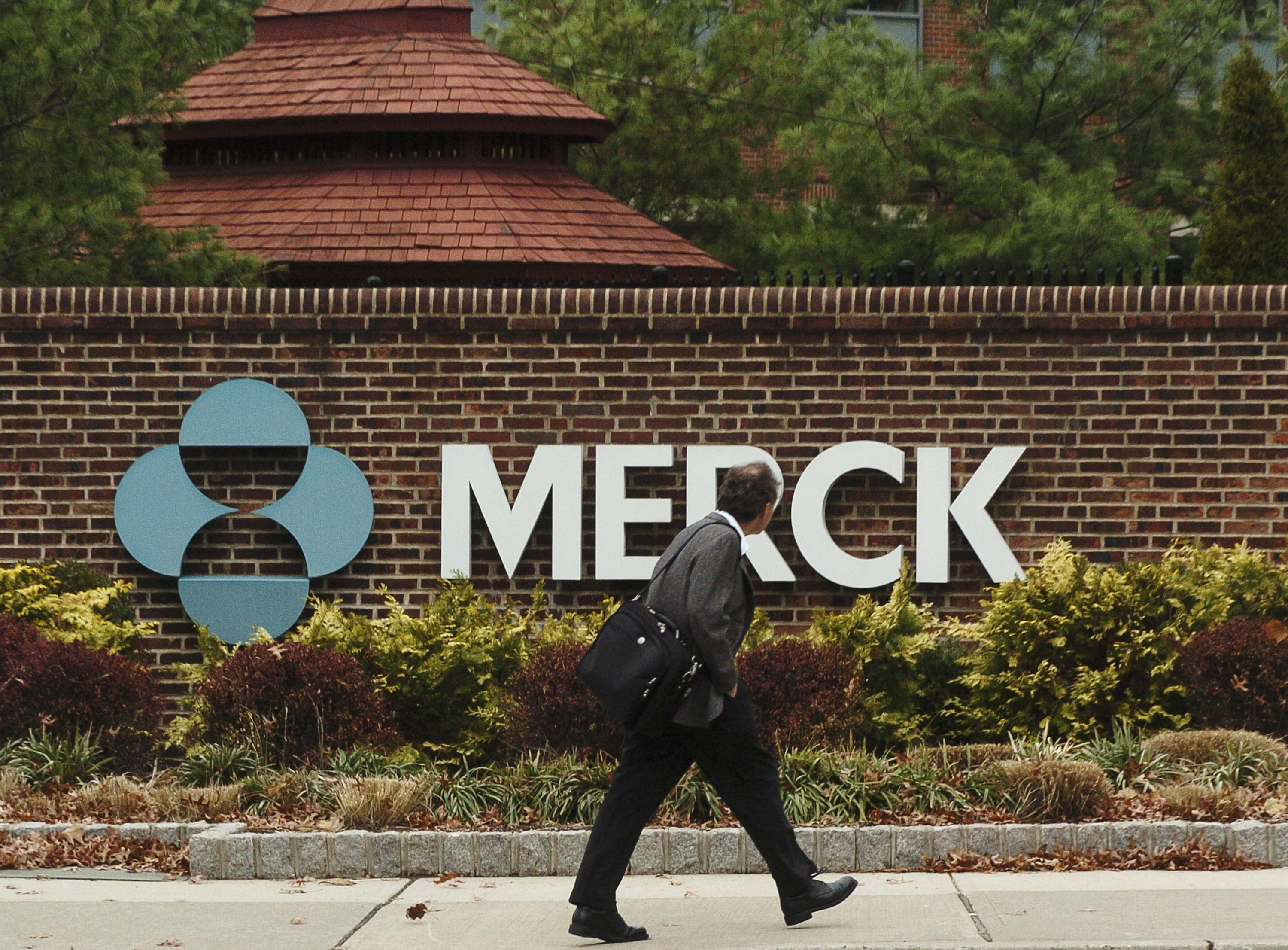 RAHWAY, NJ - NOVEMBER 29: A man walks by a sign at a Merck plant November 29, 2005 in Rahway, New Jersey. U.S. pharmaceutical giant Merck, announced plans to cut some 7,000 jobs, or 11 percent of its global workforce, by the end of 2008. (Photo by Marko Georgiev/Getty Images)