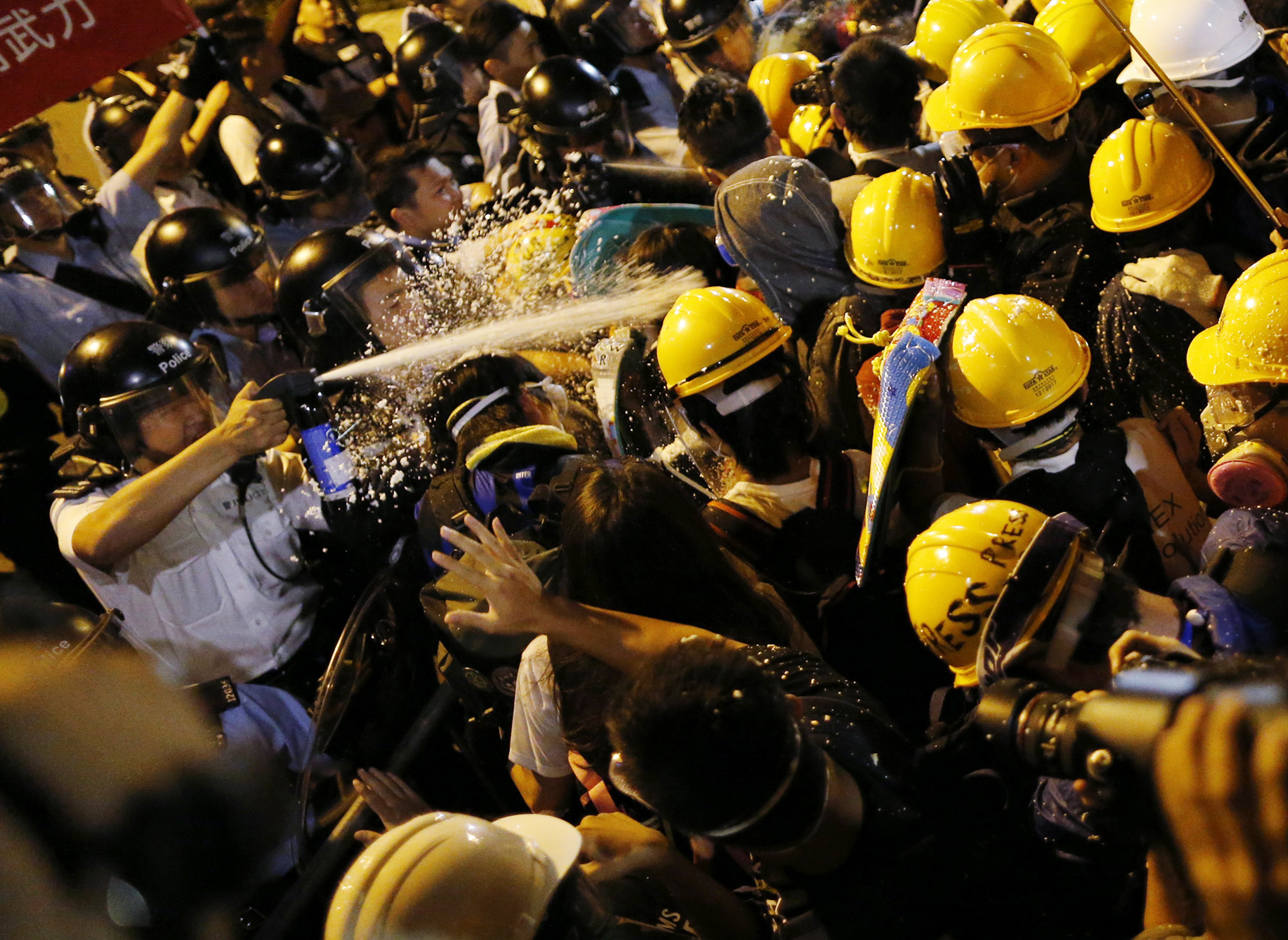 Police use pepper spray during clashes with pro-democracy protesters close to the chief executive office in Hong Kong