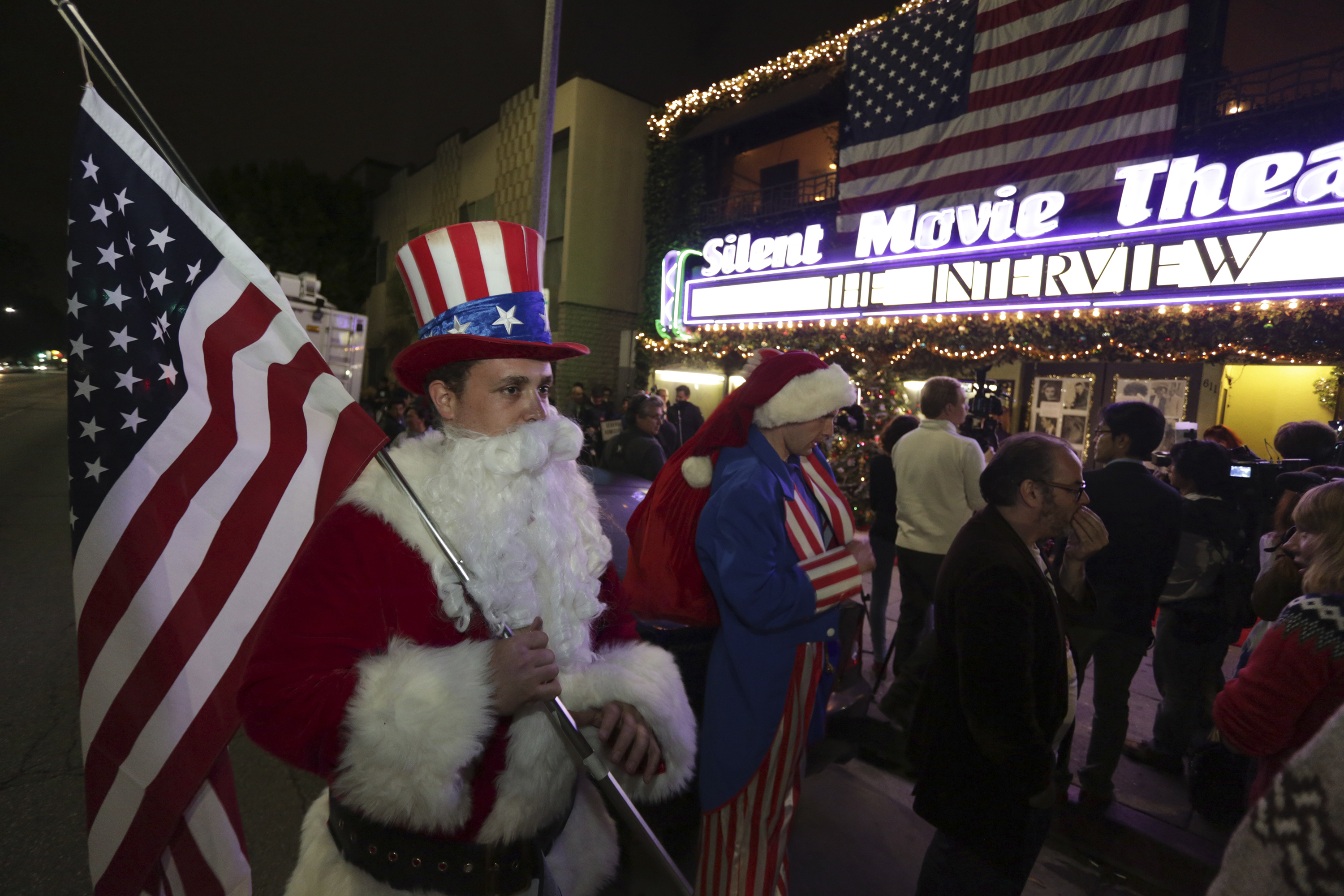 Ornstein holds an American flag as fans line up at the Silent Movie Theatre for a midnight screening of "The Interview" in Los Angeles, California