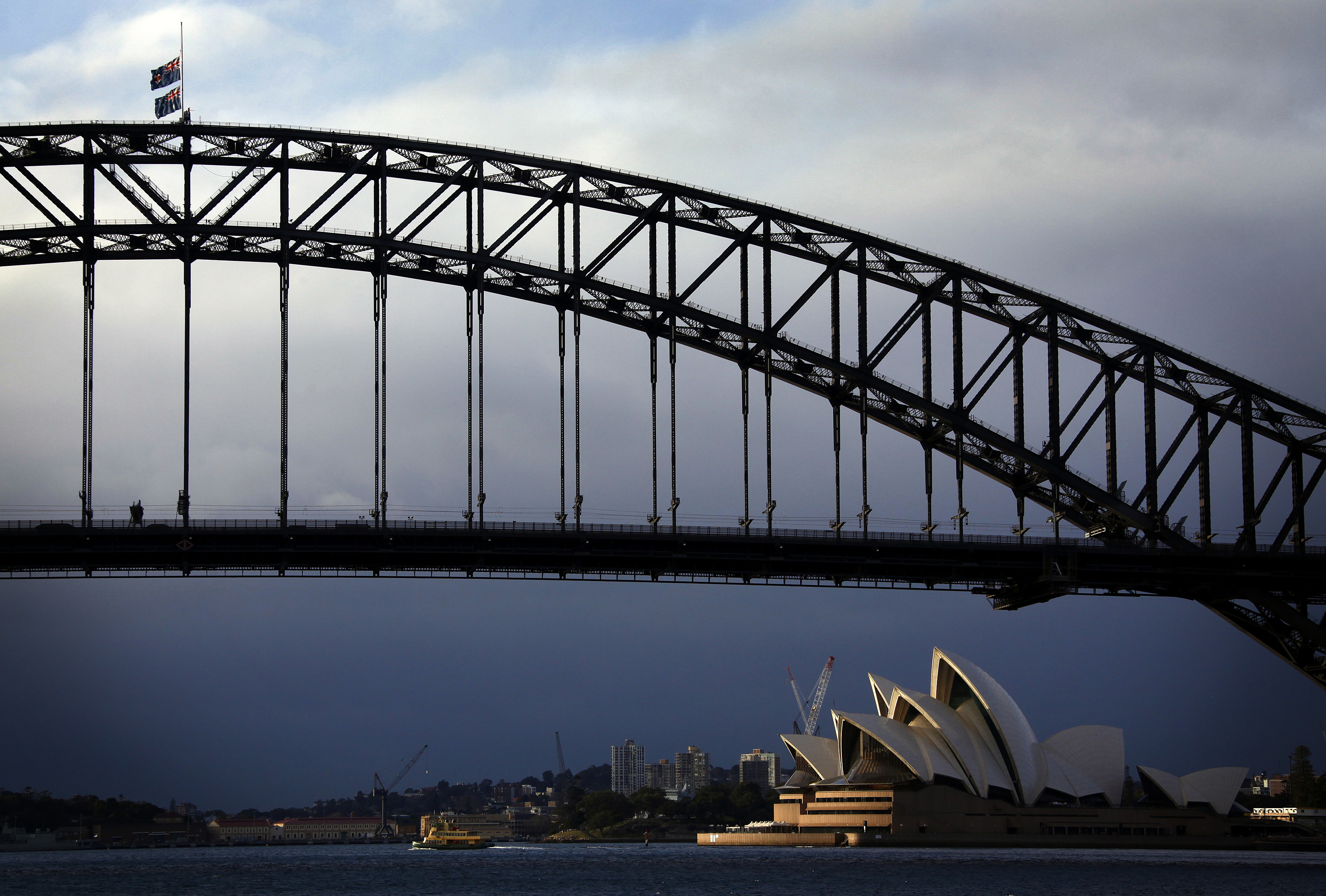 Australian flags fly at half-mast atop the Sydney Harbour Bridge as a sign of respect for those killed in the Malaysia Airlines MH17 crash