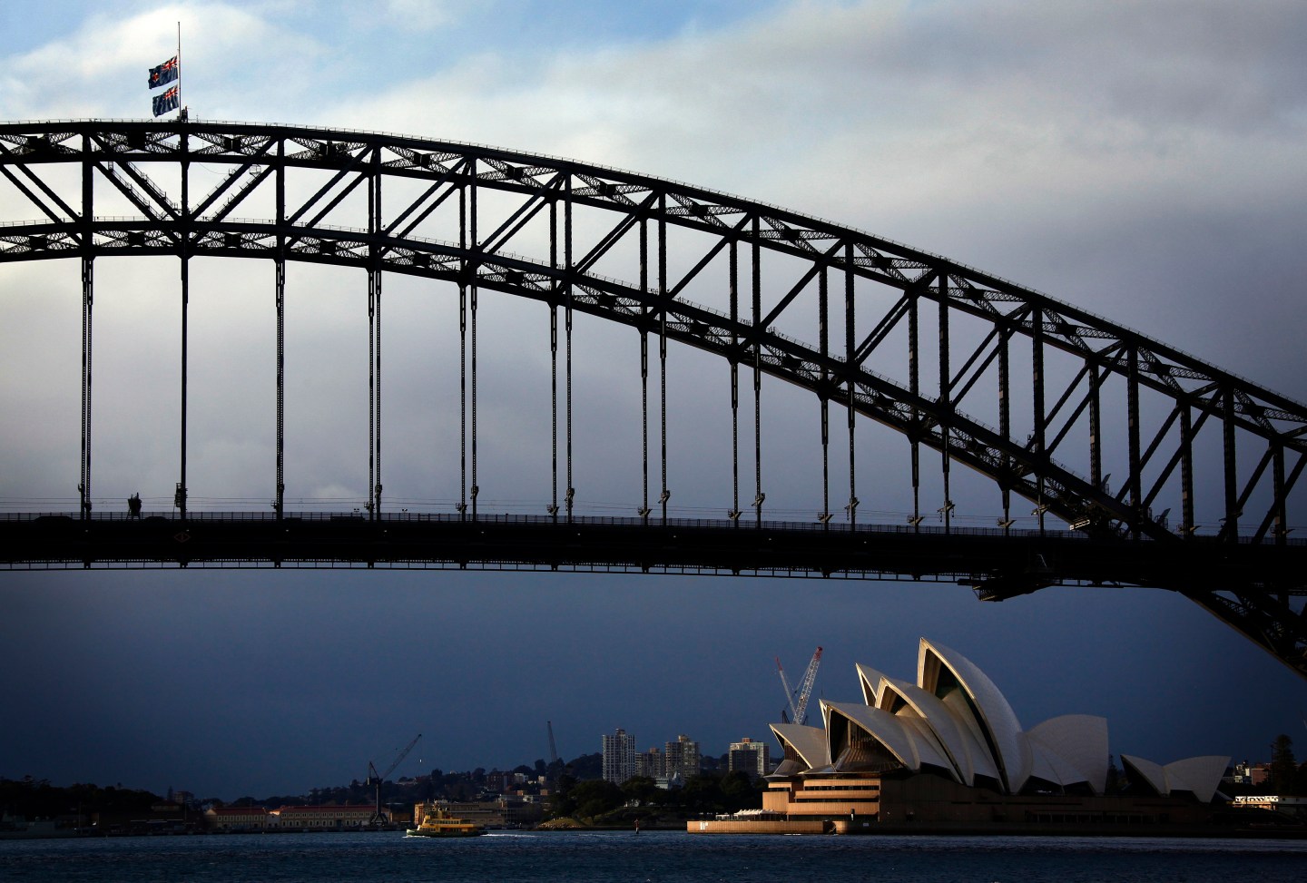 Australian flags fly at half-mast atop the Sydney Harbour Bridge as a sign of respect for those killed in the Malaysia Airlines MH17 crash
