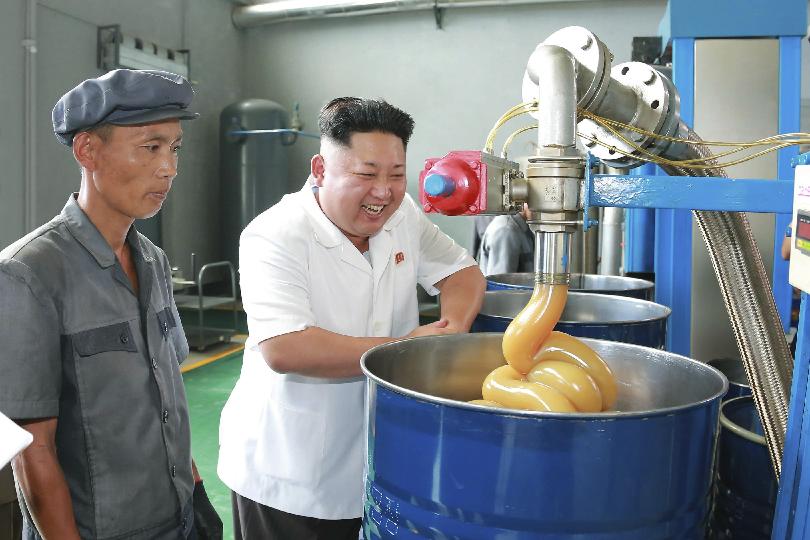 KCNA picture shows North Korean leader Kim Jong Un smiling during a visit to the Chonji Lubricant Factory