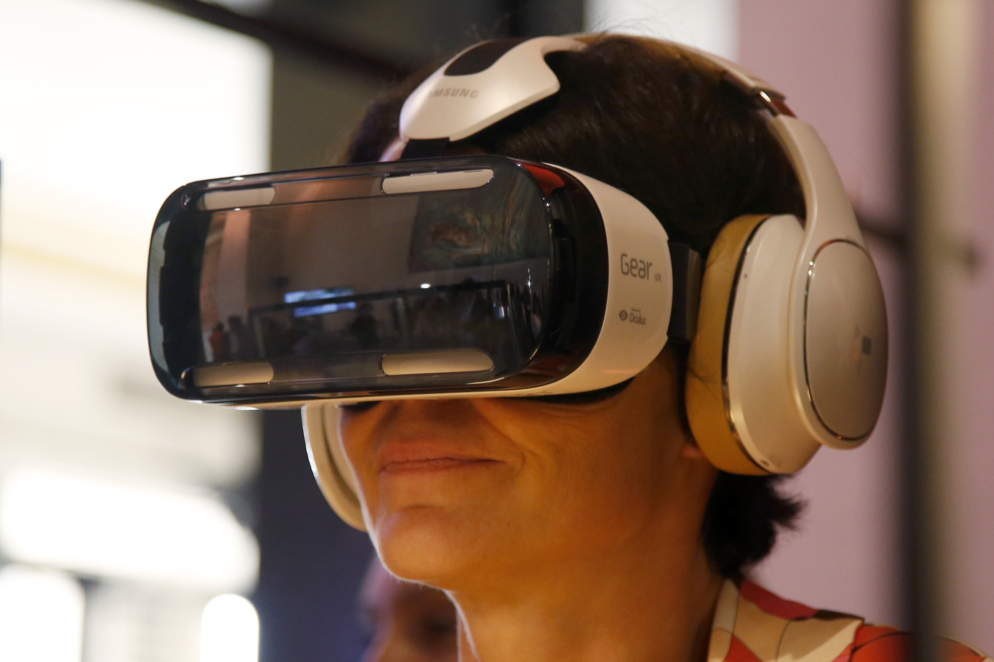 An attendee tries an Oculus-powered Samsung Gear VR headset during the French telecom Orange annual company's innovations show in Paris