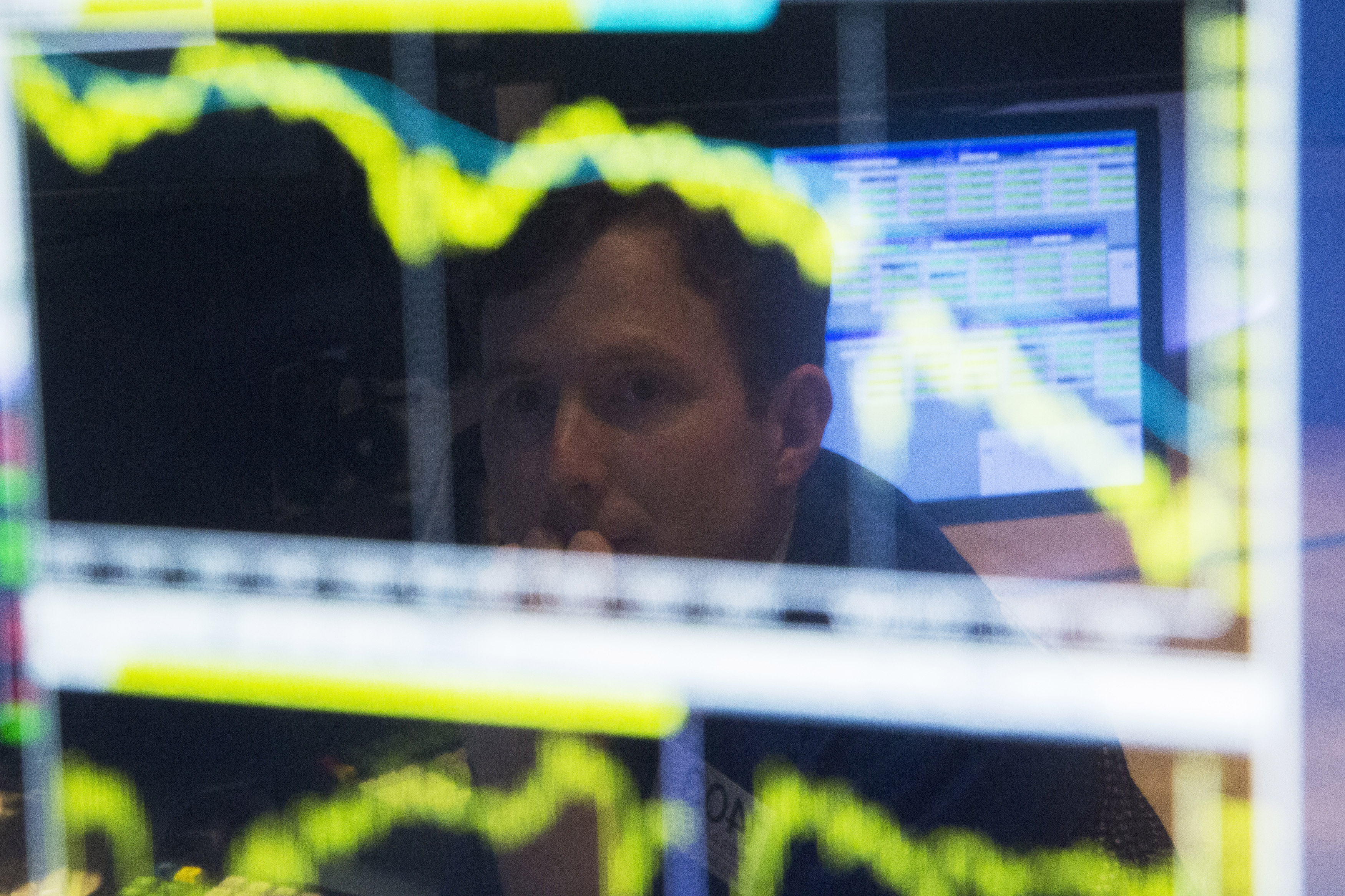 Trader watches the screen at his terminal on the floor of the New York Stock Exchange in New York
