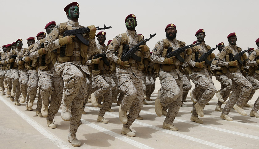 Saudi soldiers march during Abdullah's Sword military drill in Hafar Al-Batin, near the border with Kuwait