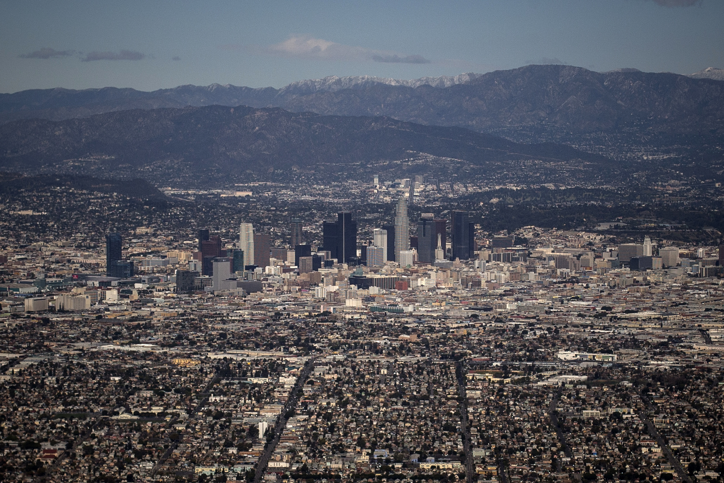 The Los Angeles skyline and the San Gabriel Mountains are seen in this aerial photo