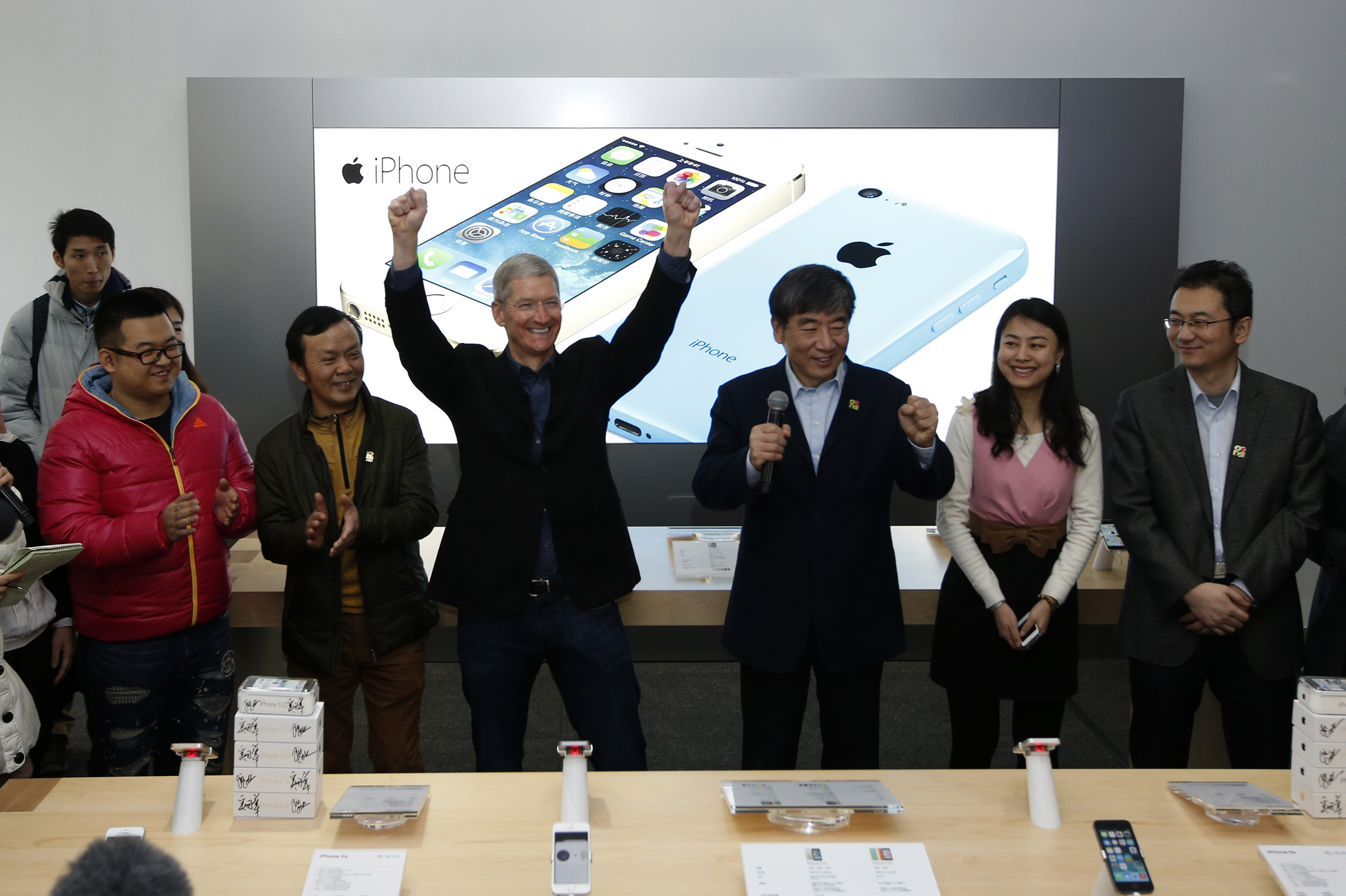 Apple Inc. CEO Tim Cook reacts at an event celebrating the launching of Apple's iPhone on China Mobile's network in Beijing