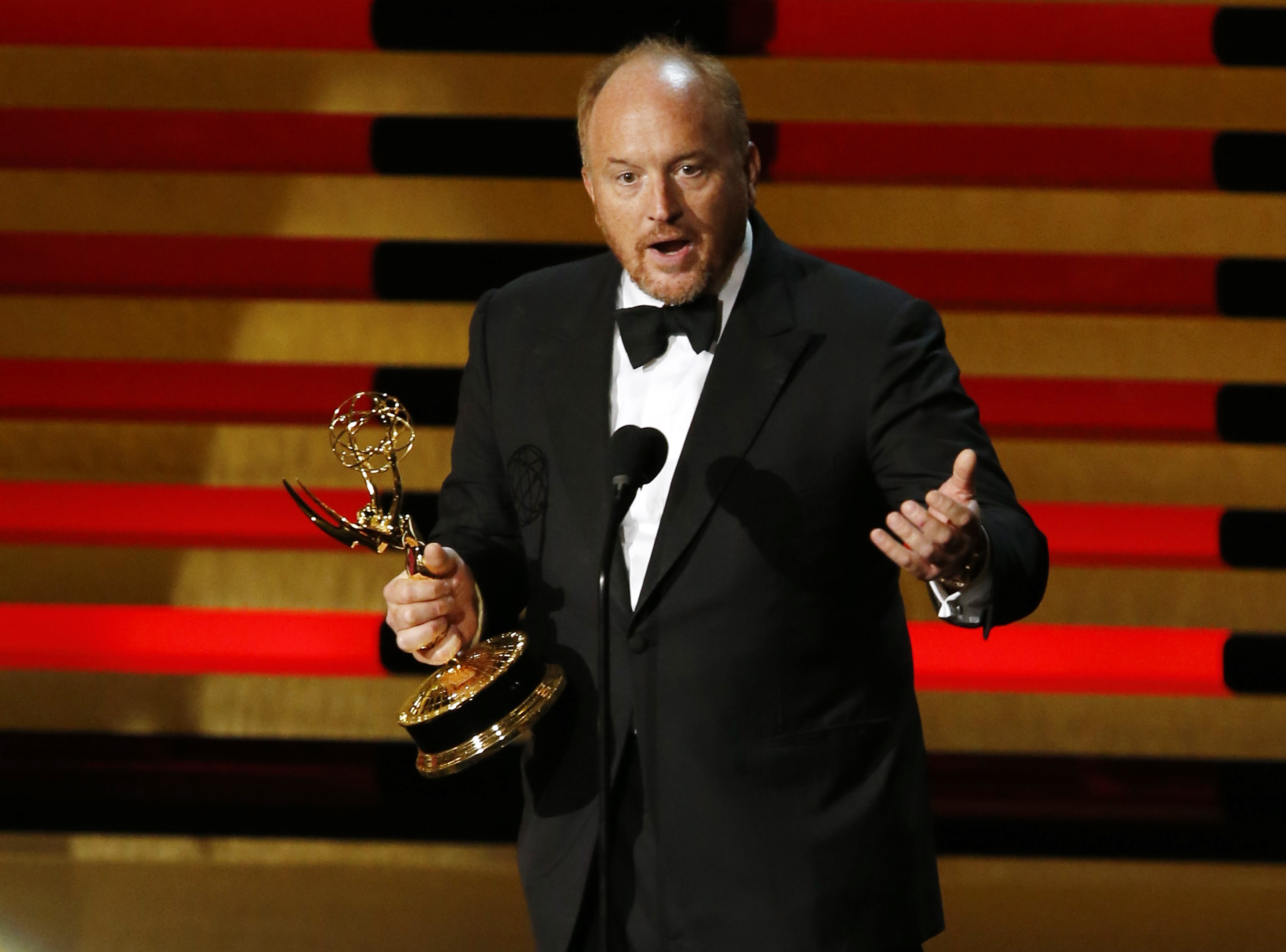 Louis C.K. accepts the Emmy award for Outstanding Writing for a Comedy Series for "Louie" onstage during the 66th Primetime Emmy Awards in Los Angeles
