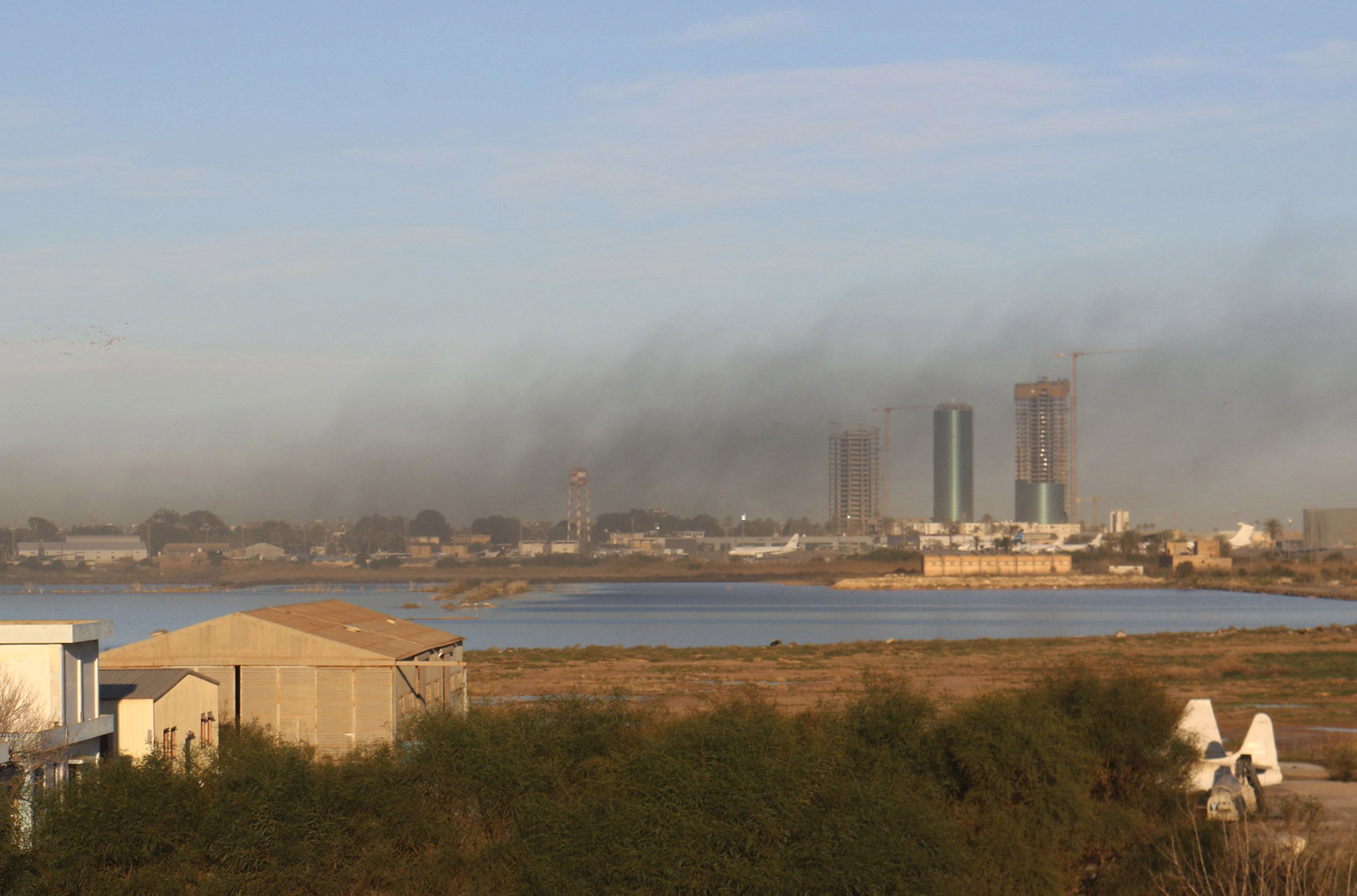Smoke rises after an airstrike hit Maitiga airport early Thursday morning, in Tripoli
