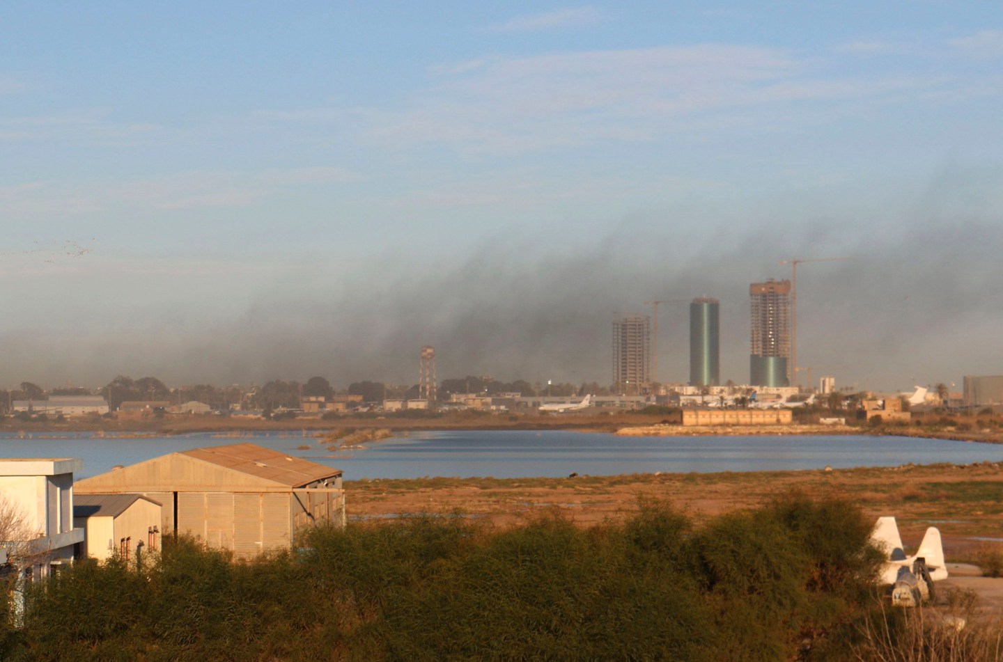 Smoke rises after an airstrike hit Maitiga airport early Thursday morning, in Tripoli