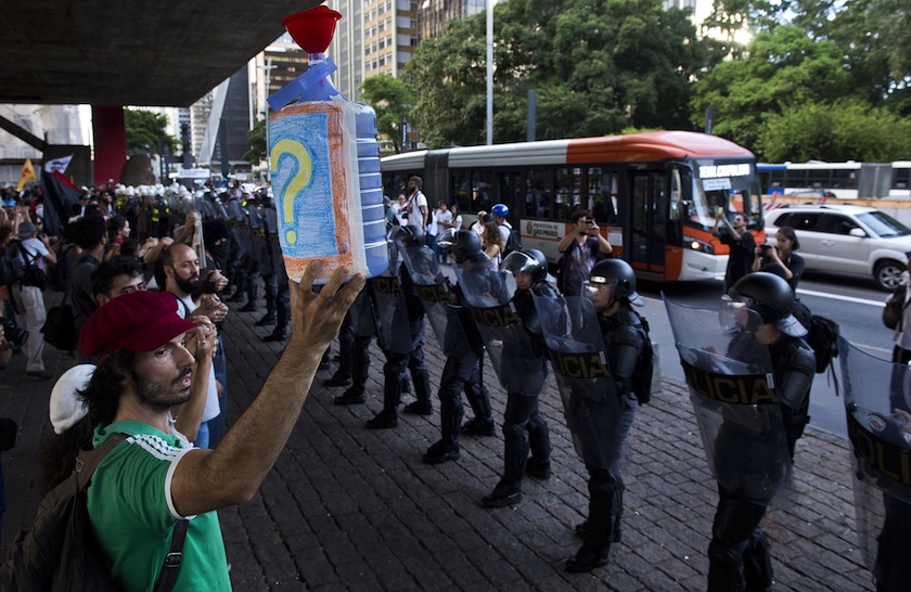 Demonstrators protest the lack of water in front of a police barricade in Sao Paulo, Brazil