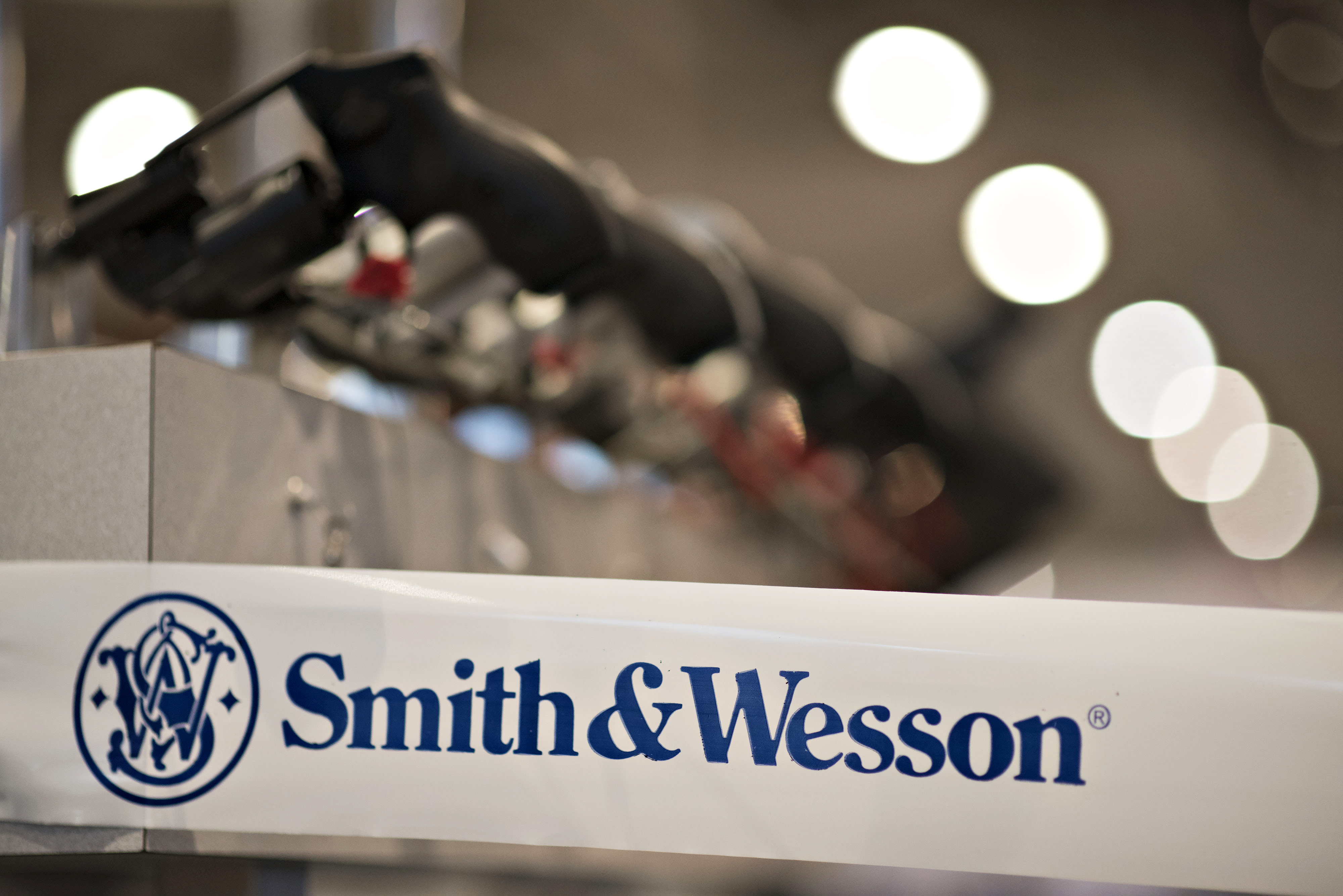 A Smith &amp; Wesson Holding Corp. logo appears on tape  surrounding the company booth on the exhibition floor ahead of the 144th National Rifle Association (NRA) Annual Meetings and Exhibits at the Music City Center in Nashville, Tennessee, U.S., on Thursday, April 9, 2015. Top Republican contenders for their party's 2016 presidential nomination are lining up to speak at the annual NRA event, except New Jersey Governor Chris Christie and Kentucky Senator Rand Paul who were snubbed by the country's largest and most powerful gun lobby. Photographer: Daniel Acker/Bloomberg