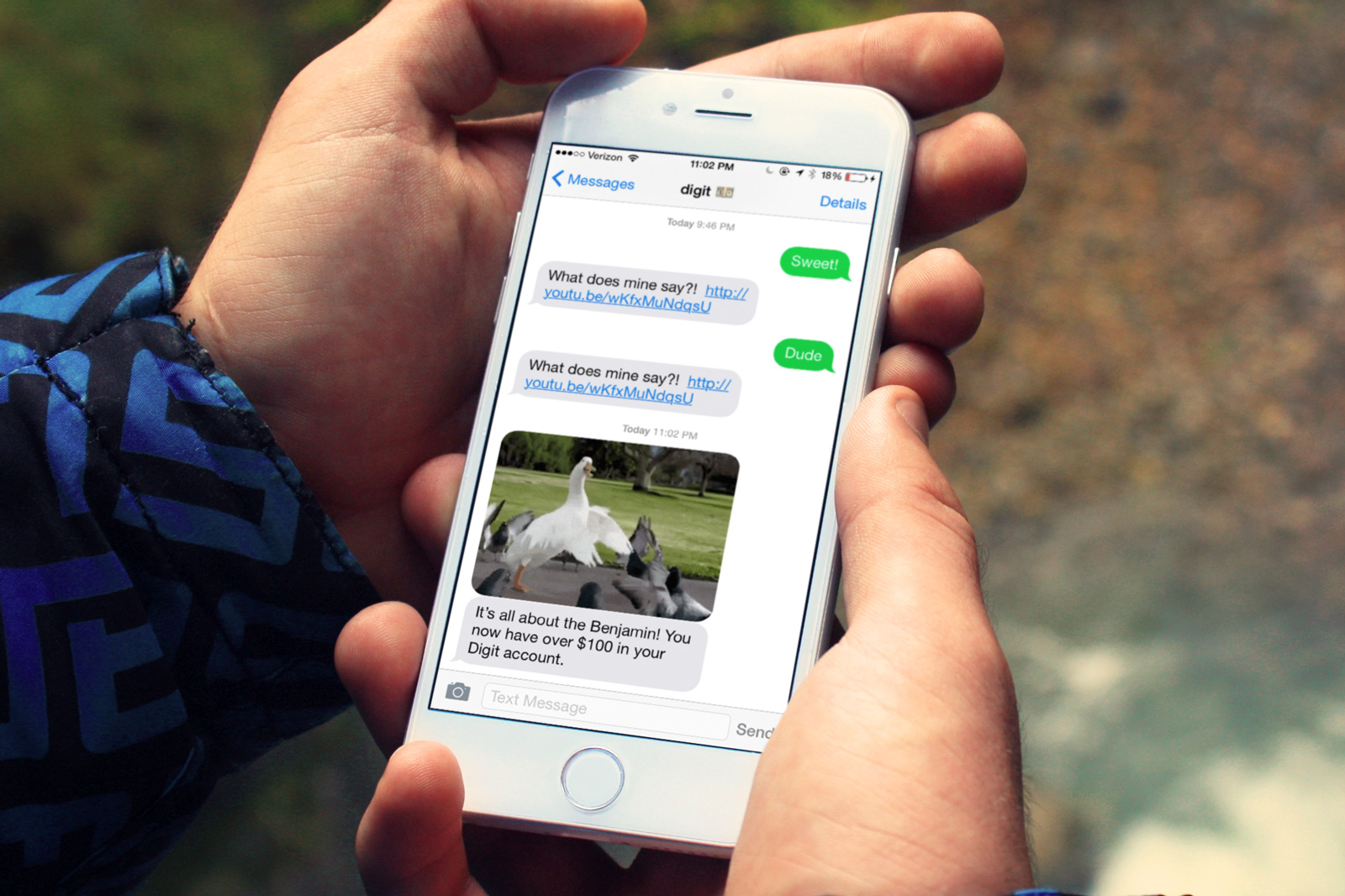A text message is seen congratulating a Digit user for reaching $100 saved.