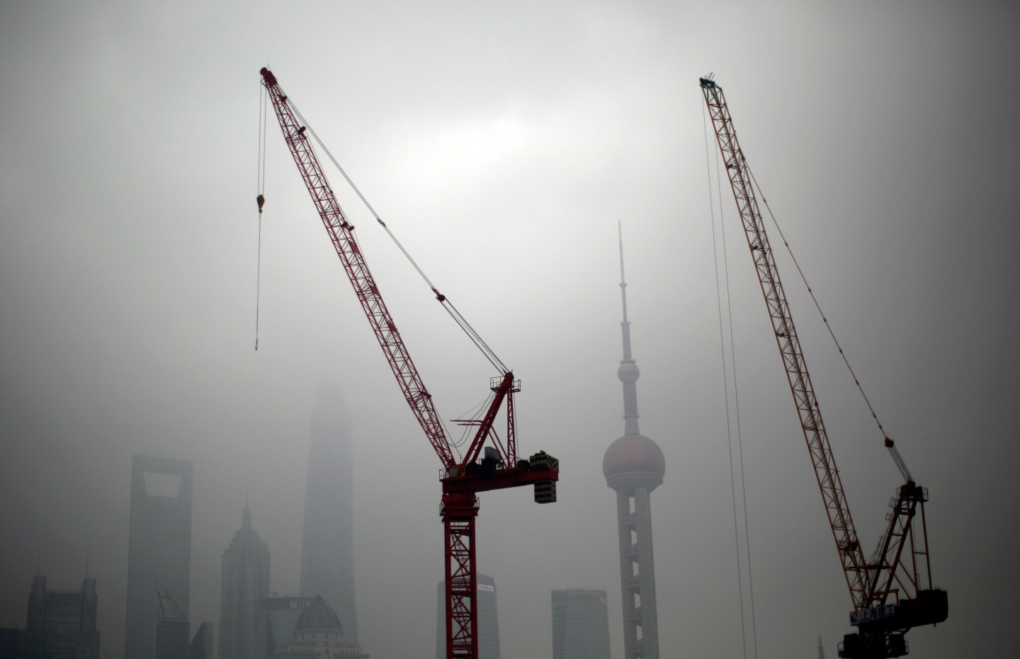 Construction cranes are see near Pudong financial district of Shanghai