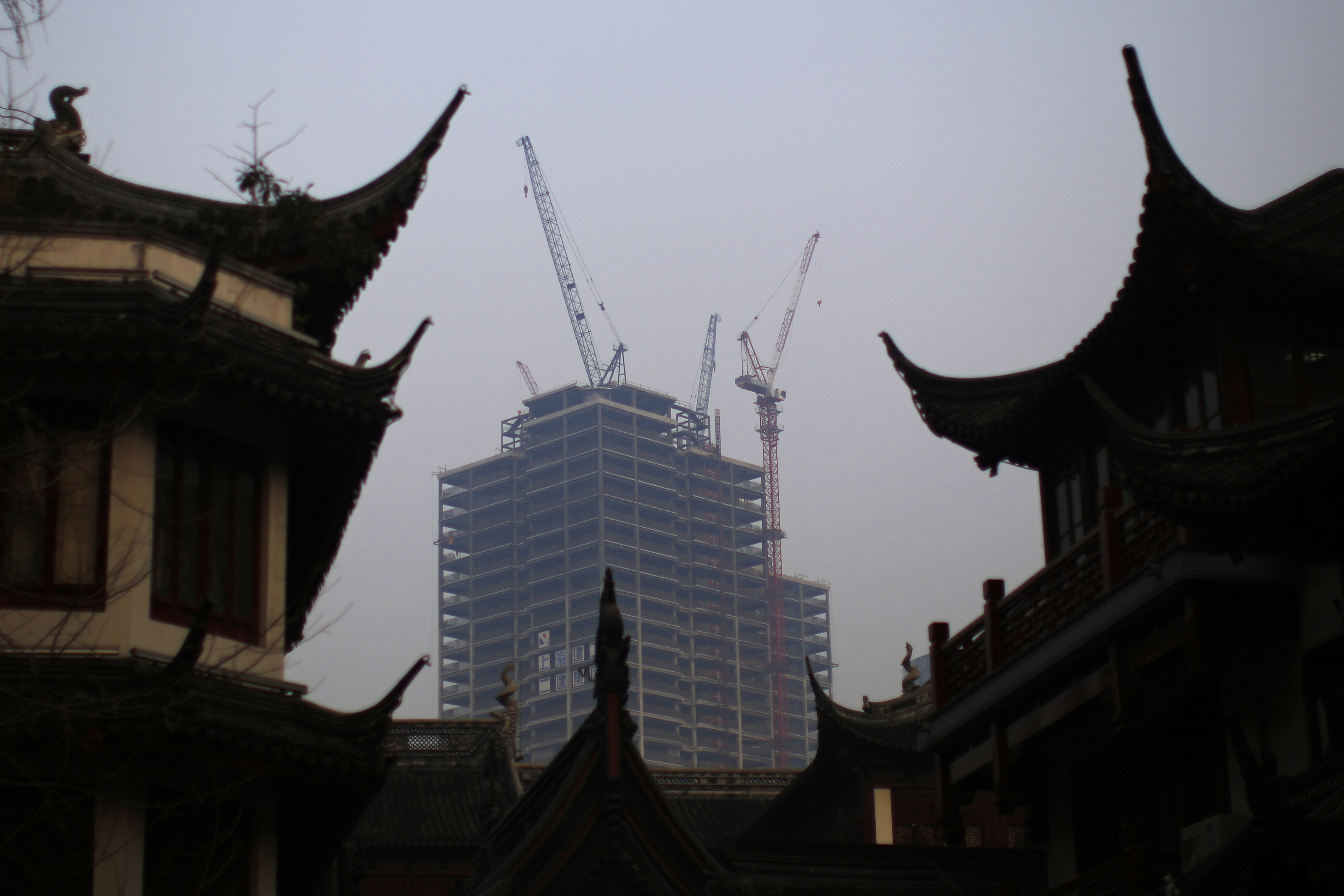 A building under construction is seen near the traditional Yu Yuan Garden in downtown Shanghai