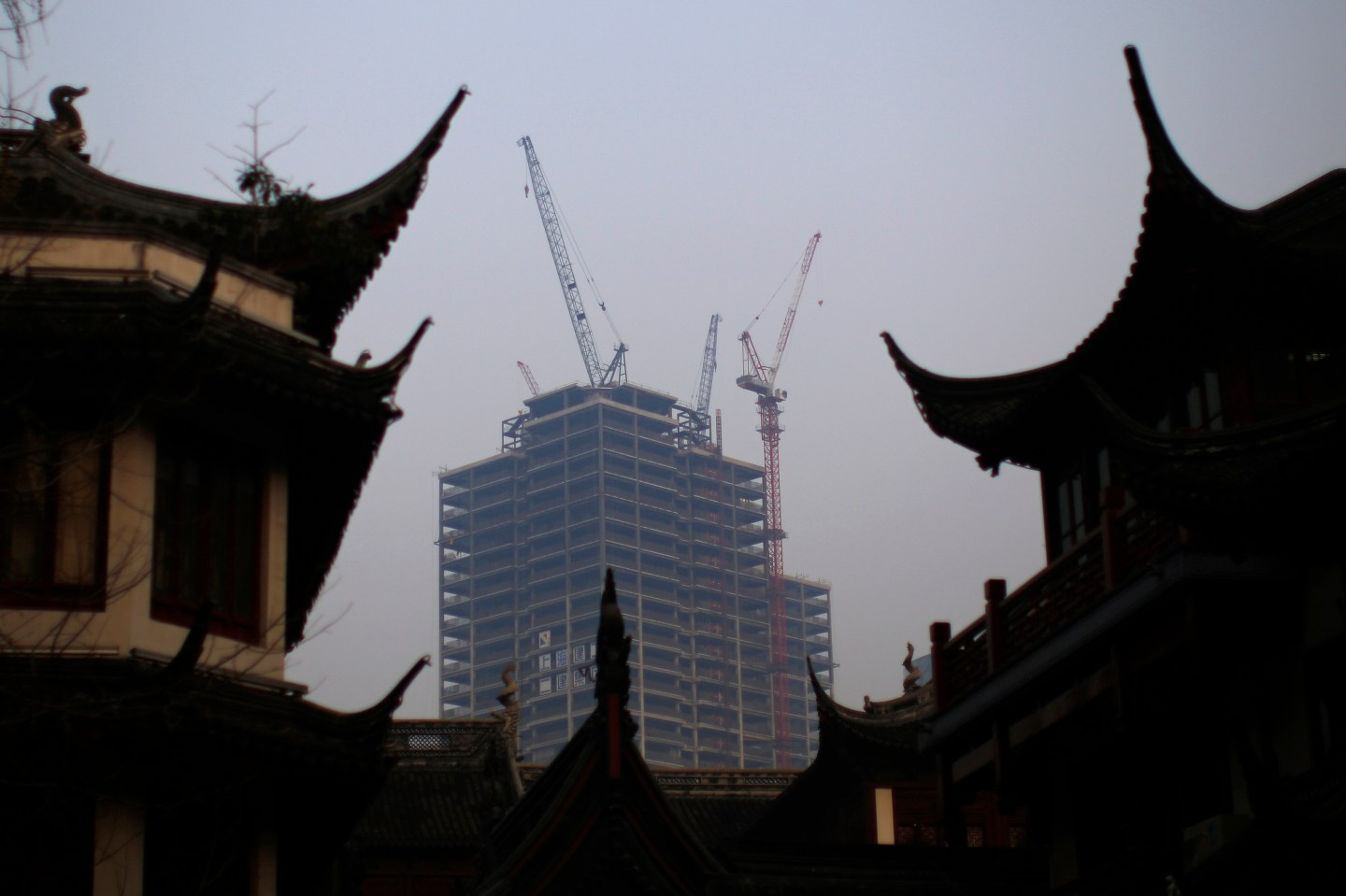 A building under construction is seen near the traditional Yu Yuan Garden in downtown Shanghai