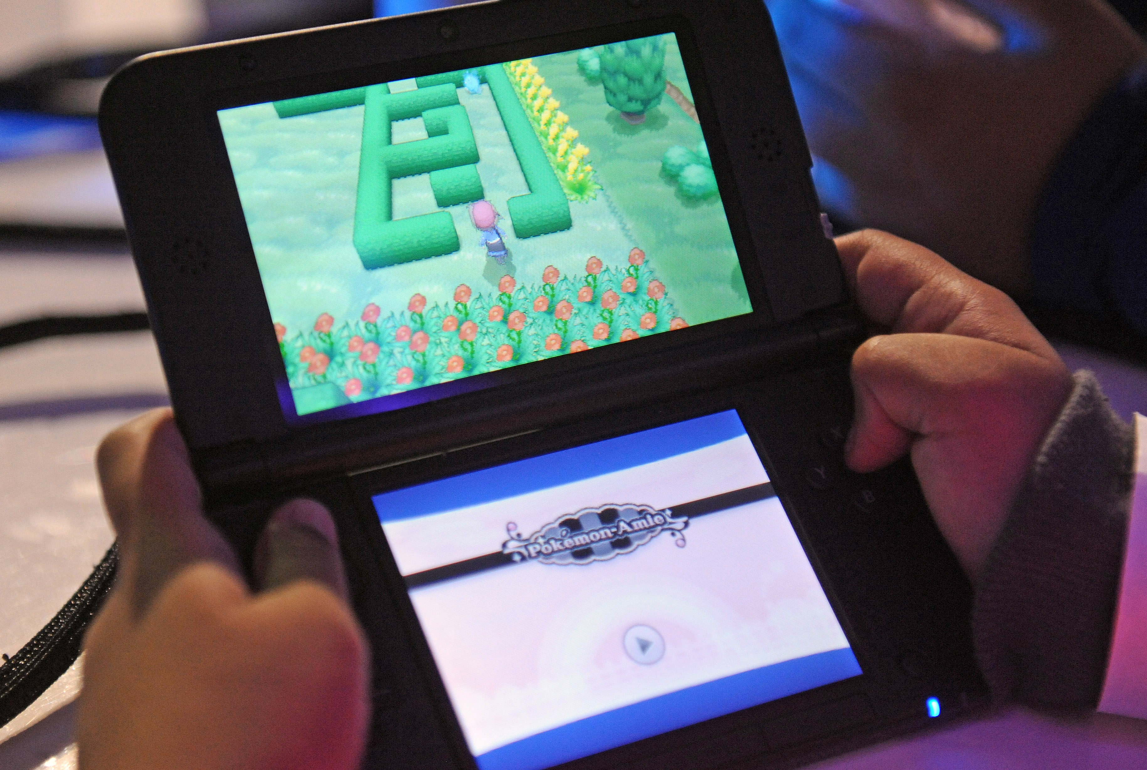 Attendees play a demo version of Pokemon X and Pokemon Y on the Nintendo 3DS at one of several kiosks  in New York on Friday, Oct. 11, 2013.The event celebrates the release of the two new games. Photographer: Louis Lanzano/ Bloomberg *** Local Caption *** Nintendo