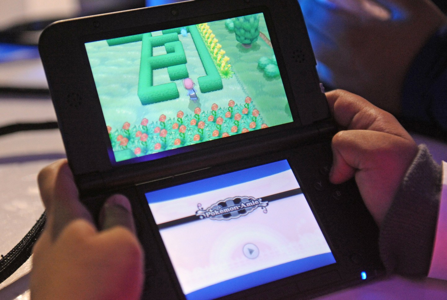 Attendees play a demo version of Pokemon X and Pokemon Y on the Nintendo 3DS at one of several kiosks  in New York on Friday, Oct. 11, 2013.The event celebrates the release of the two new games. Photographer: Louis Lanzano/ Bloomberg *** Local Caption *** Nintendo