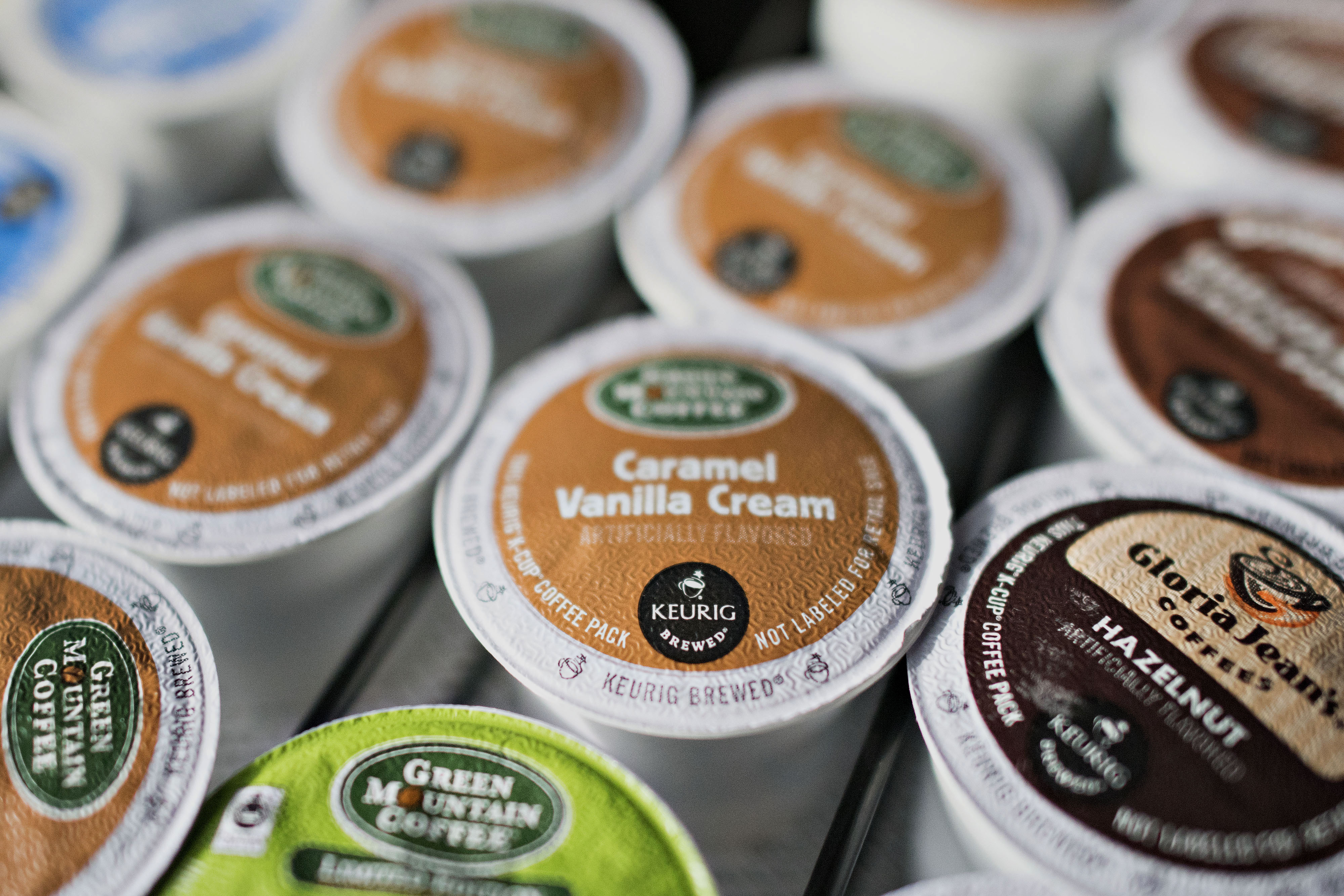 Keurig Green Mountain Inc. "K-cup" coffee pods sit near a coffee machine in a salon in Princeton, Illinois, U.S., on Tuesday, Feb. 3, 2015. Keurig Green Mountain Inc., is scheduled to report quarterly earnings on Feb. 4. Photographer:  Daniel Acker/Bloomberg