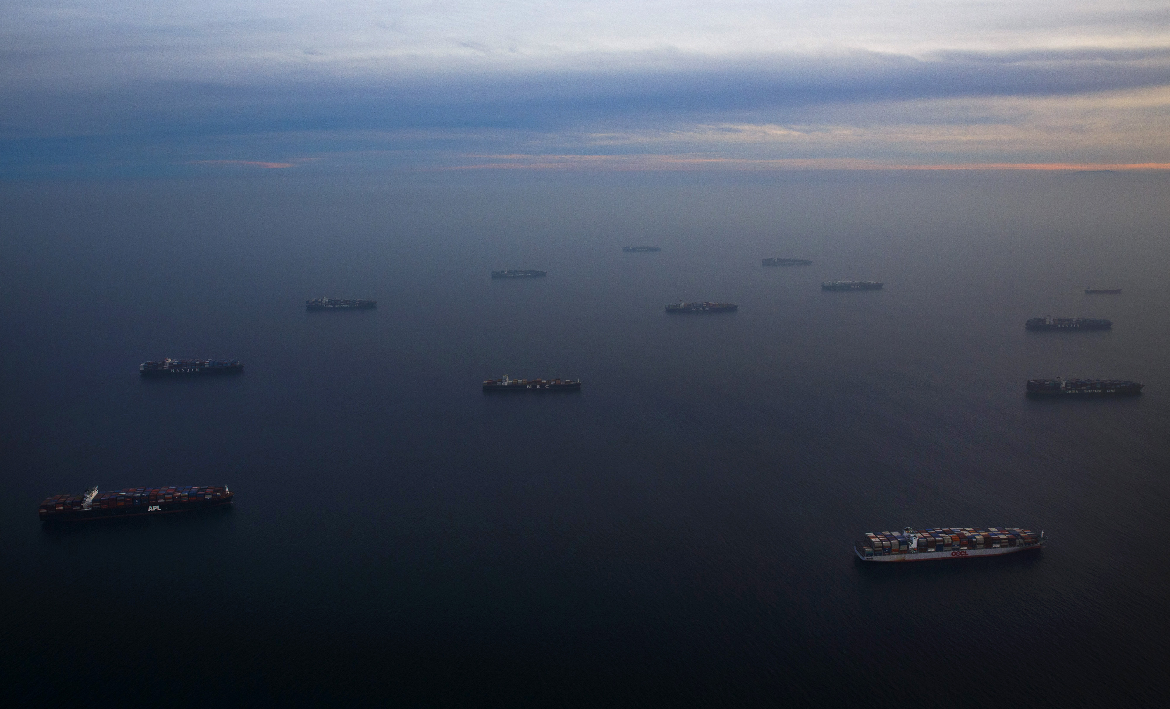 Ships waiting to unload cargo are seen waiting in the Pacific Ocean in this aerial photograph taken above the Port Of Los Angeles in Los Angeles, California, U.S., on Wednesday, Feb. 18, 2015. United Steelworkers members who help run crude terminals at a California port are threatening to join a national oil workers’ strike at U.S. refineries. Photographer: Patrick T. Fallon/Bloomberg