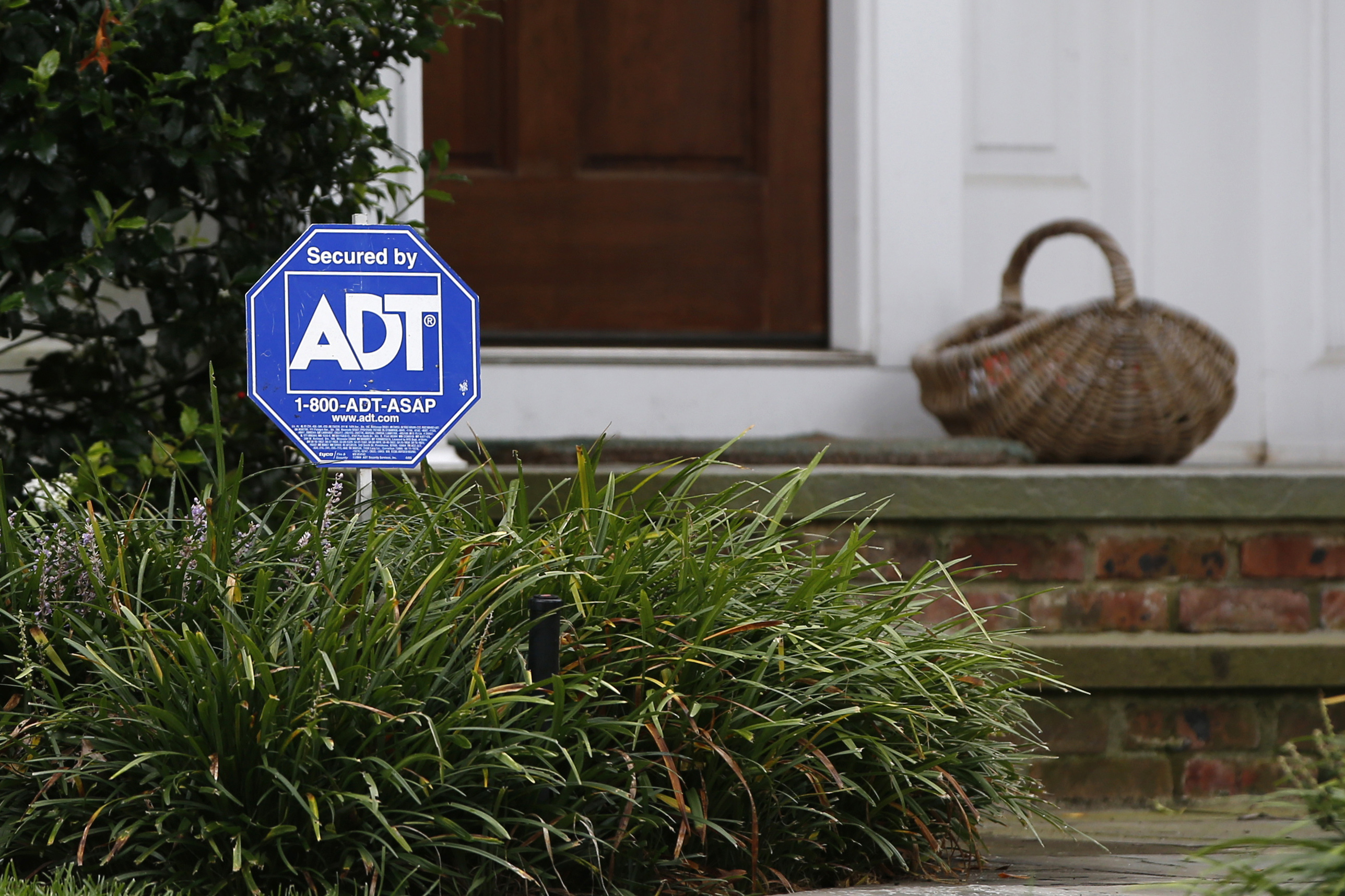 A security sign for ADT is seen outside a home in Port Washington, New York