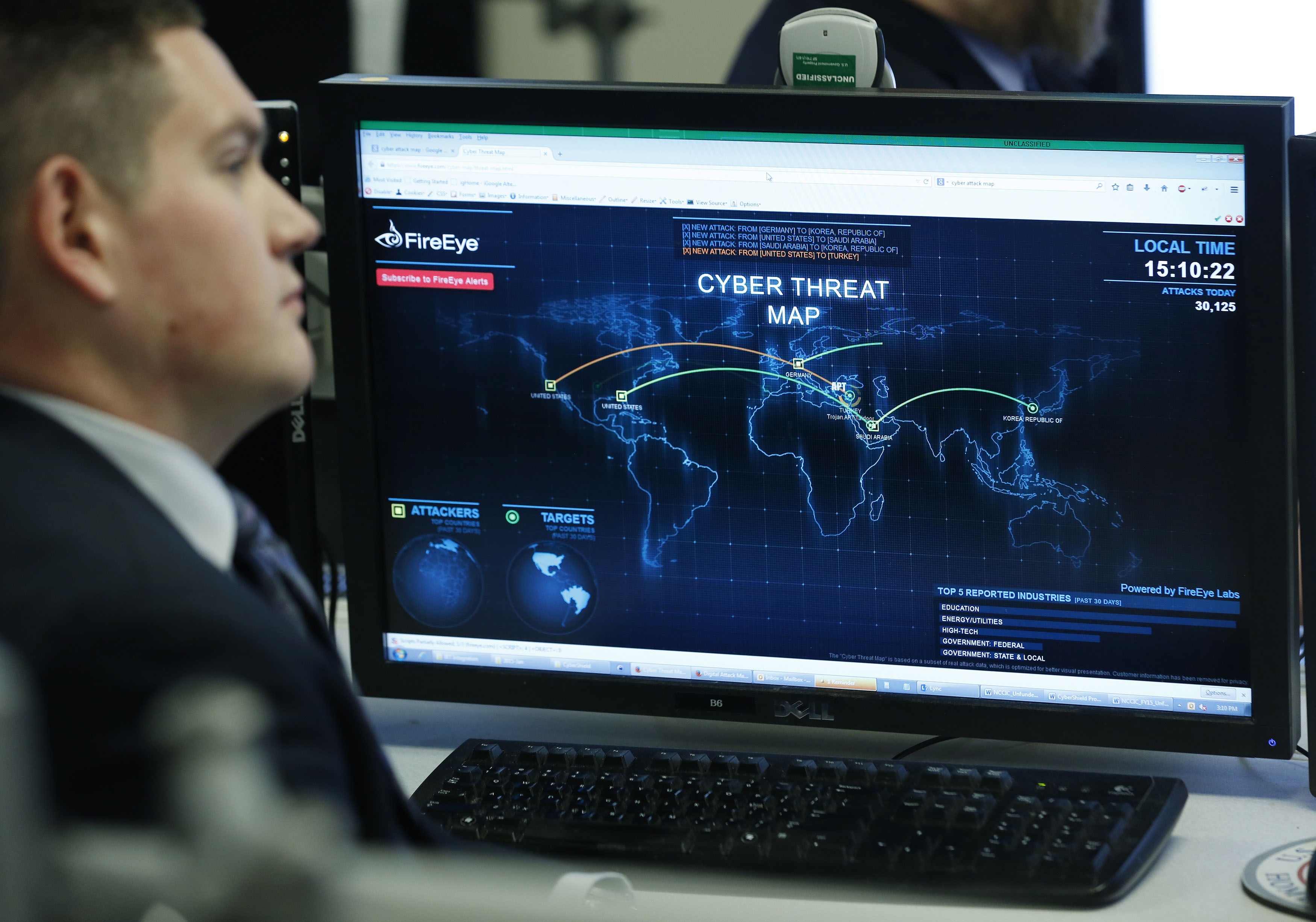 A Department of Homeland Security worker listen to U.S. President Barack Obama talk at the National Cybersecurity and Communications Integration Center in Arlington