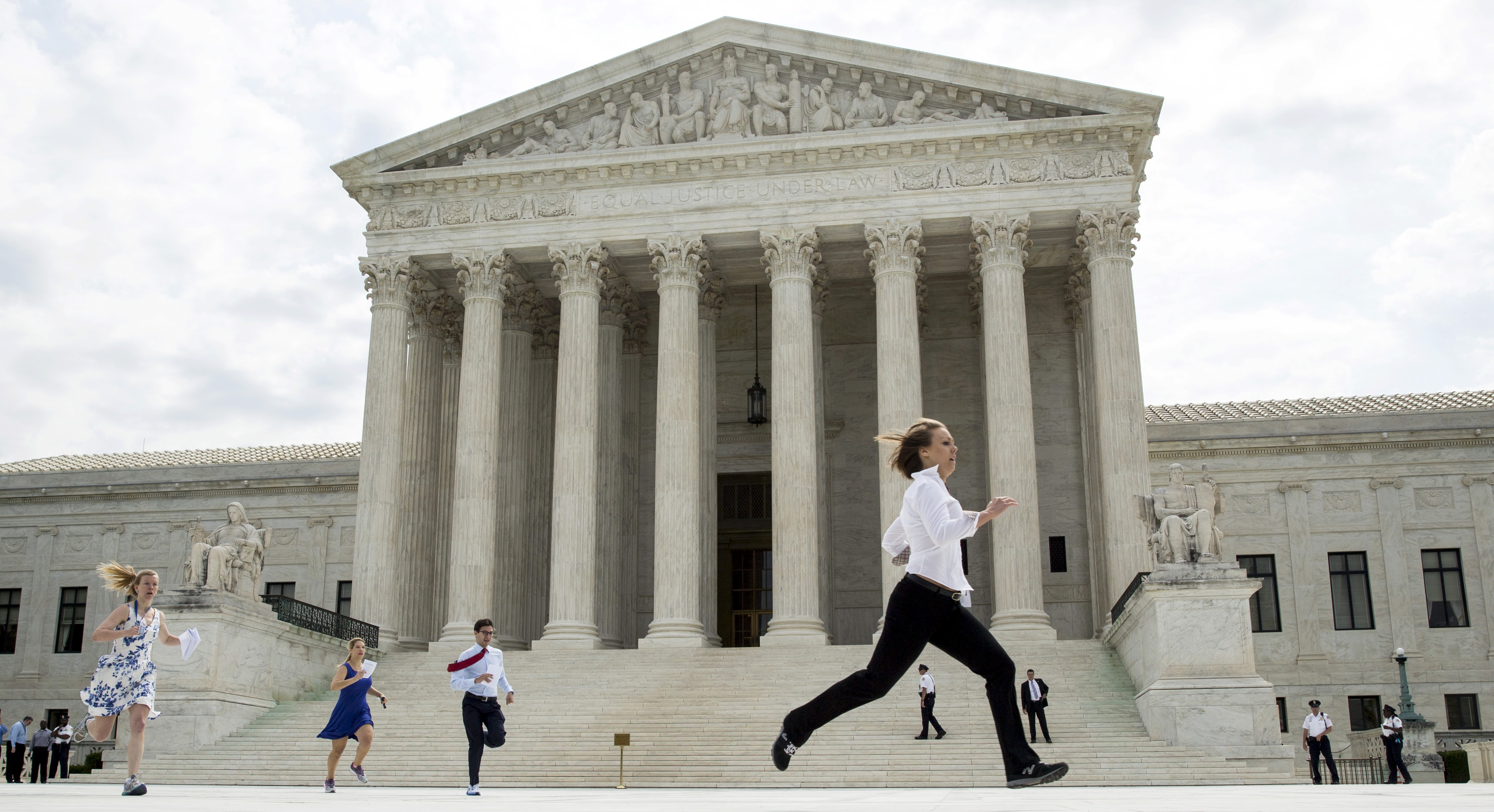 Interns with media organizations run with the decision upholding the Affordable Care Act at the Supreme Court in Washington