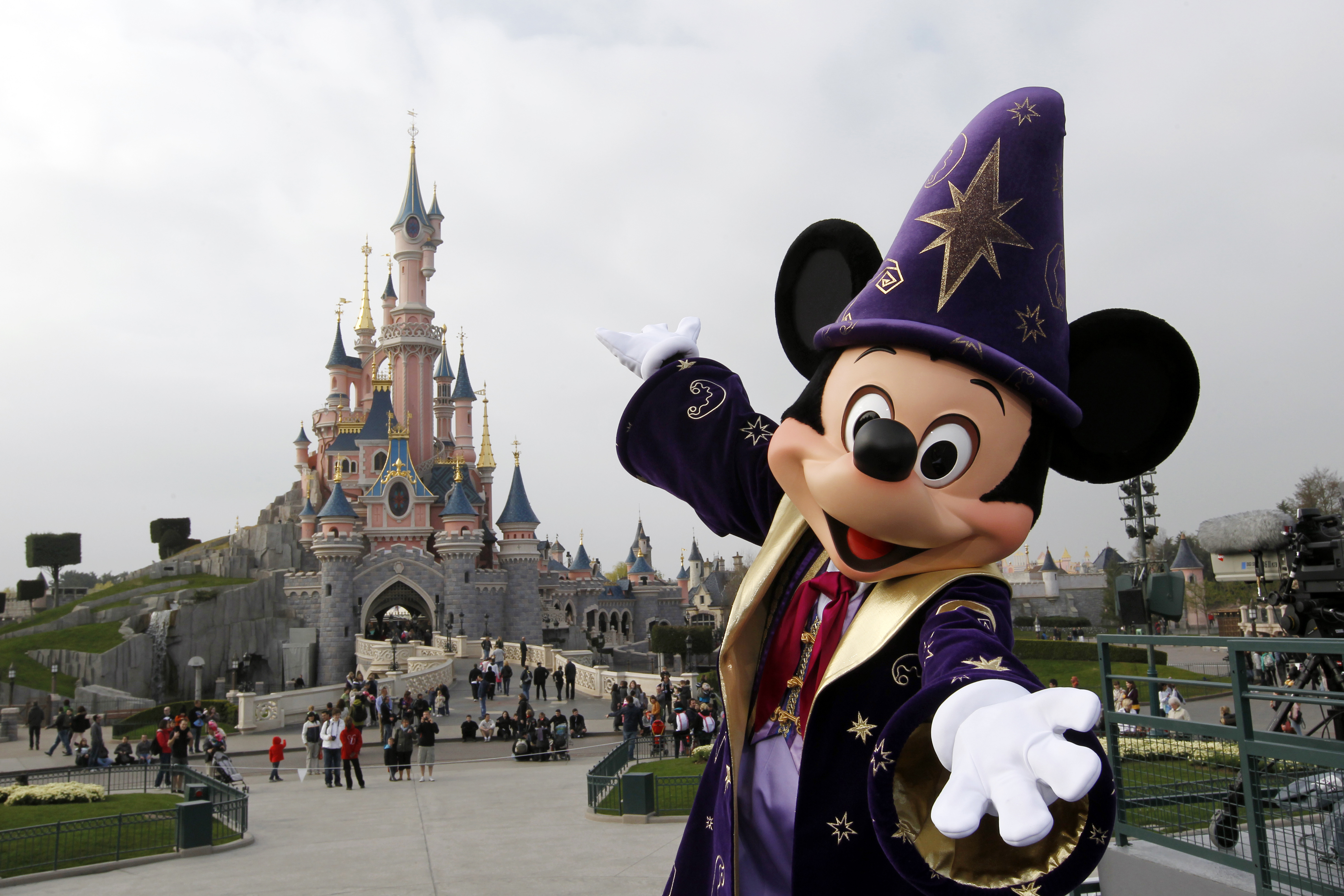 Disney character Mickey poses in front o