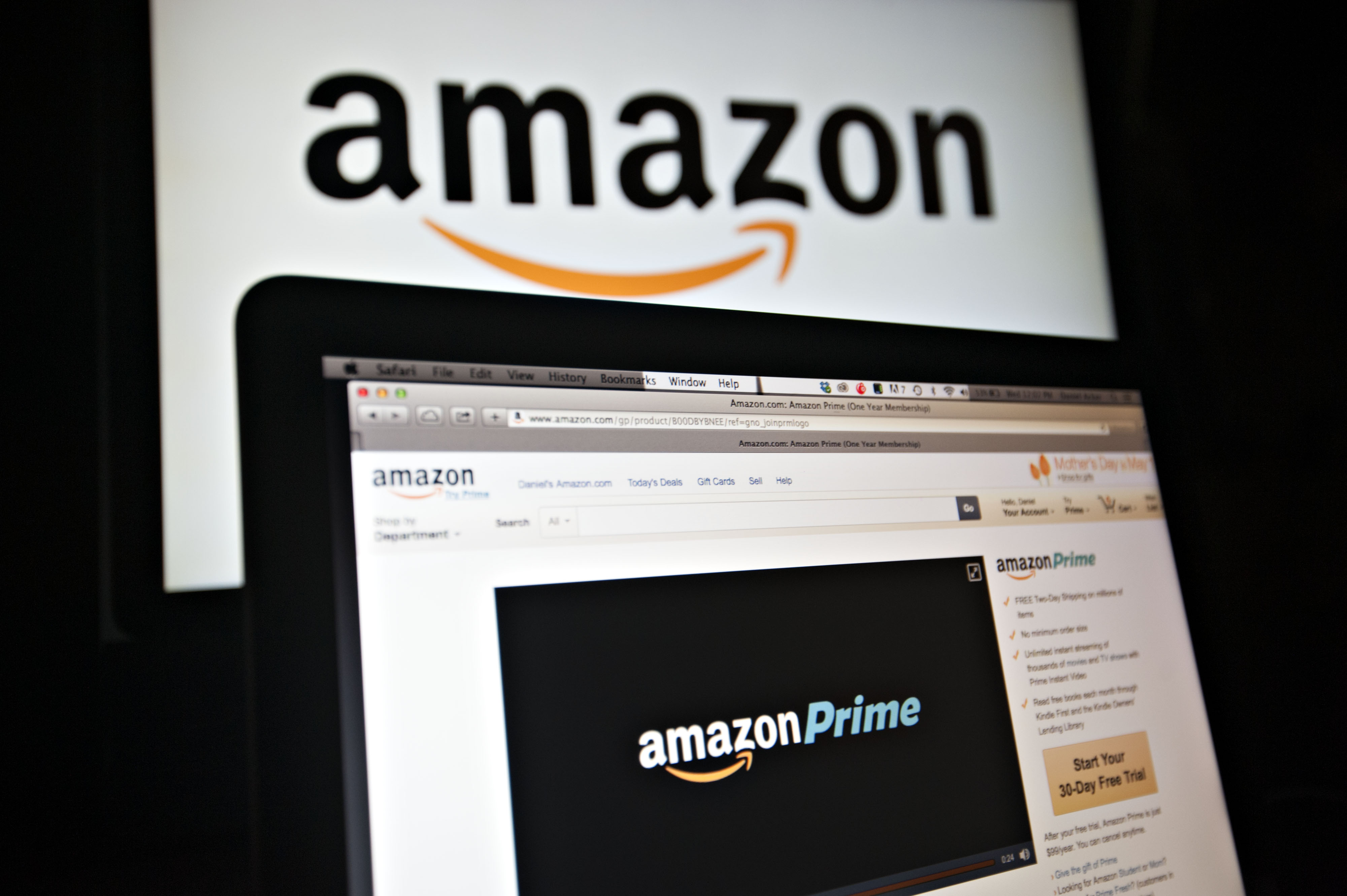 Amazon's Prime logo is displayed on computer screens.