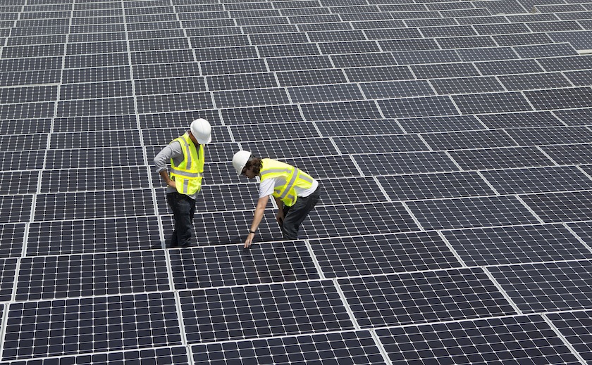 Technicians working on solar panels