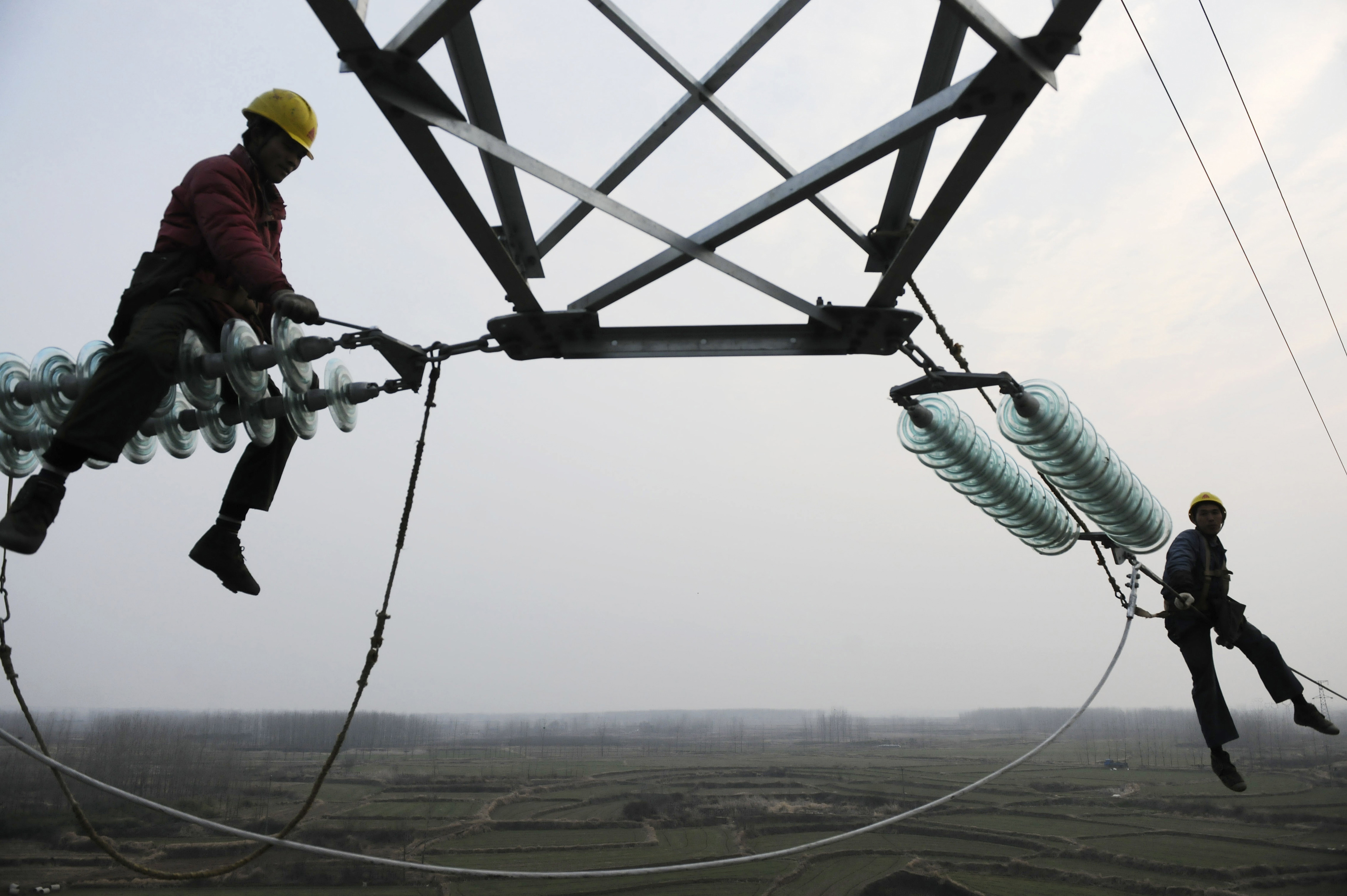 Employees work on a pylon in Chuzhou