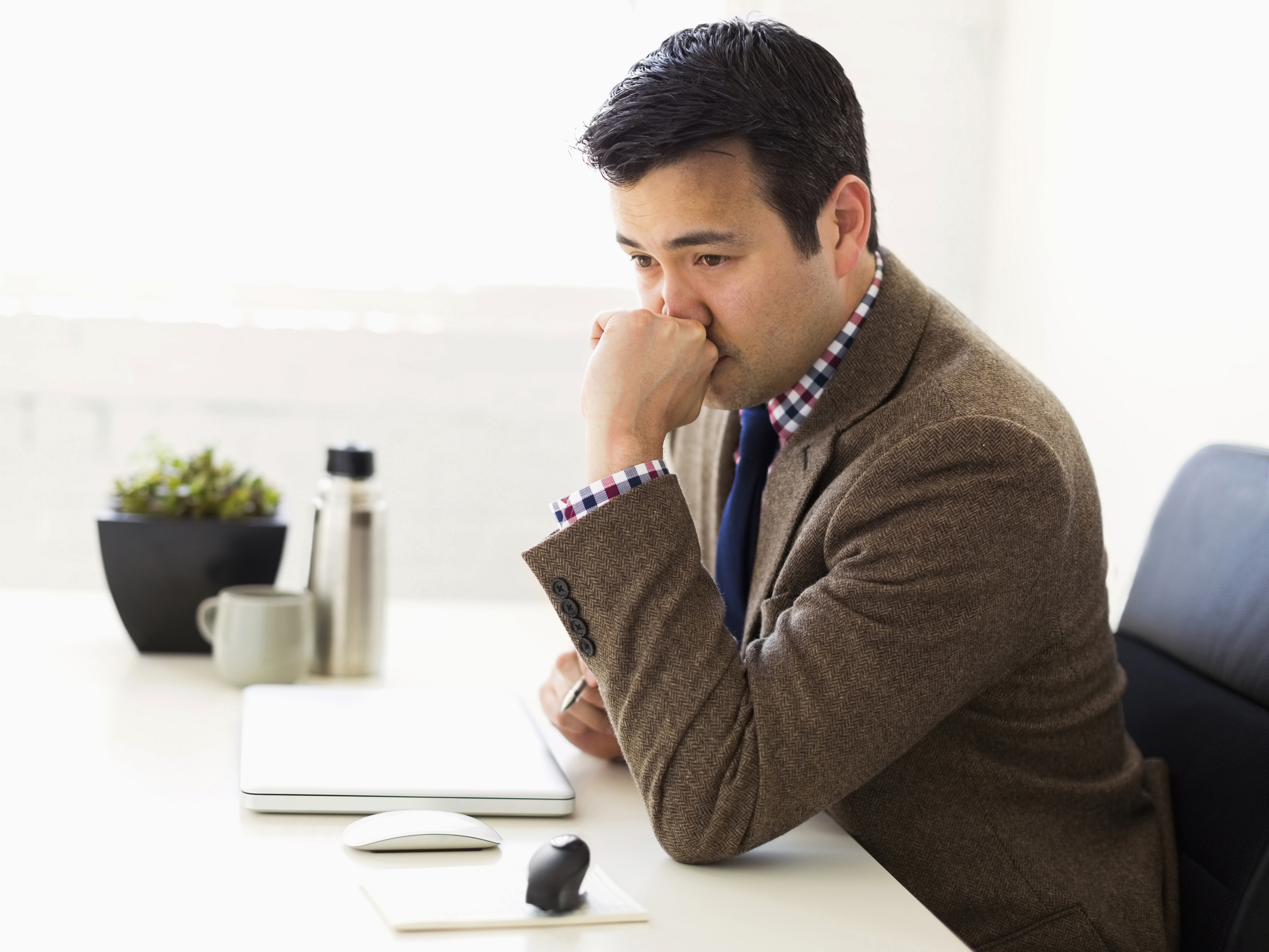 Businessman sitting in office and thinking