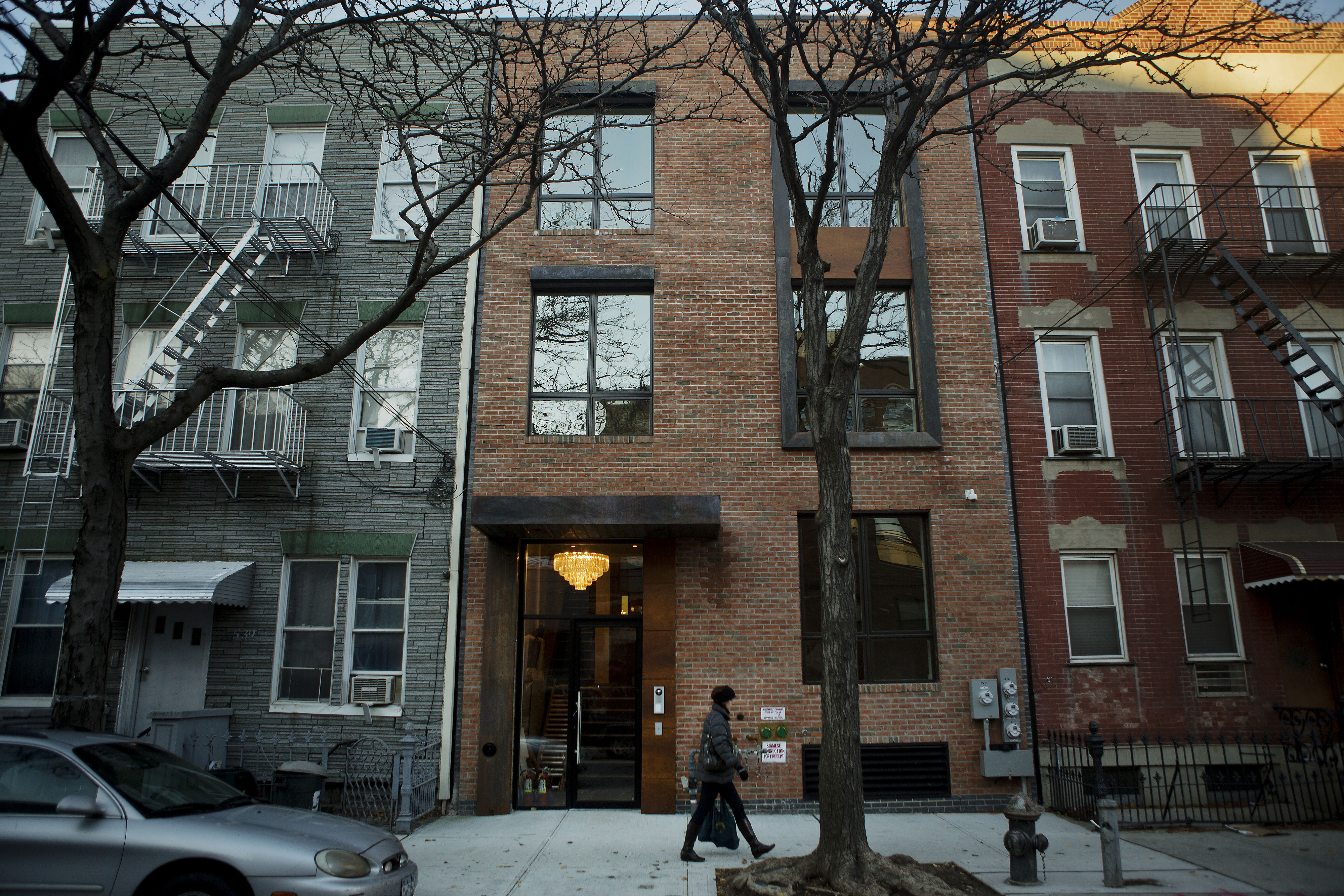 A pedestrian walks past the FiveFortyOne, a three-condo project located at 5-41 47th Road, in the Queens borough of New York, U.S. Young Americans are waiting longer than ever to buy their first home, a study has shown.