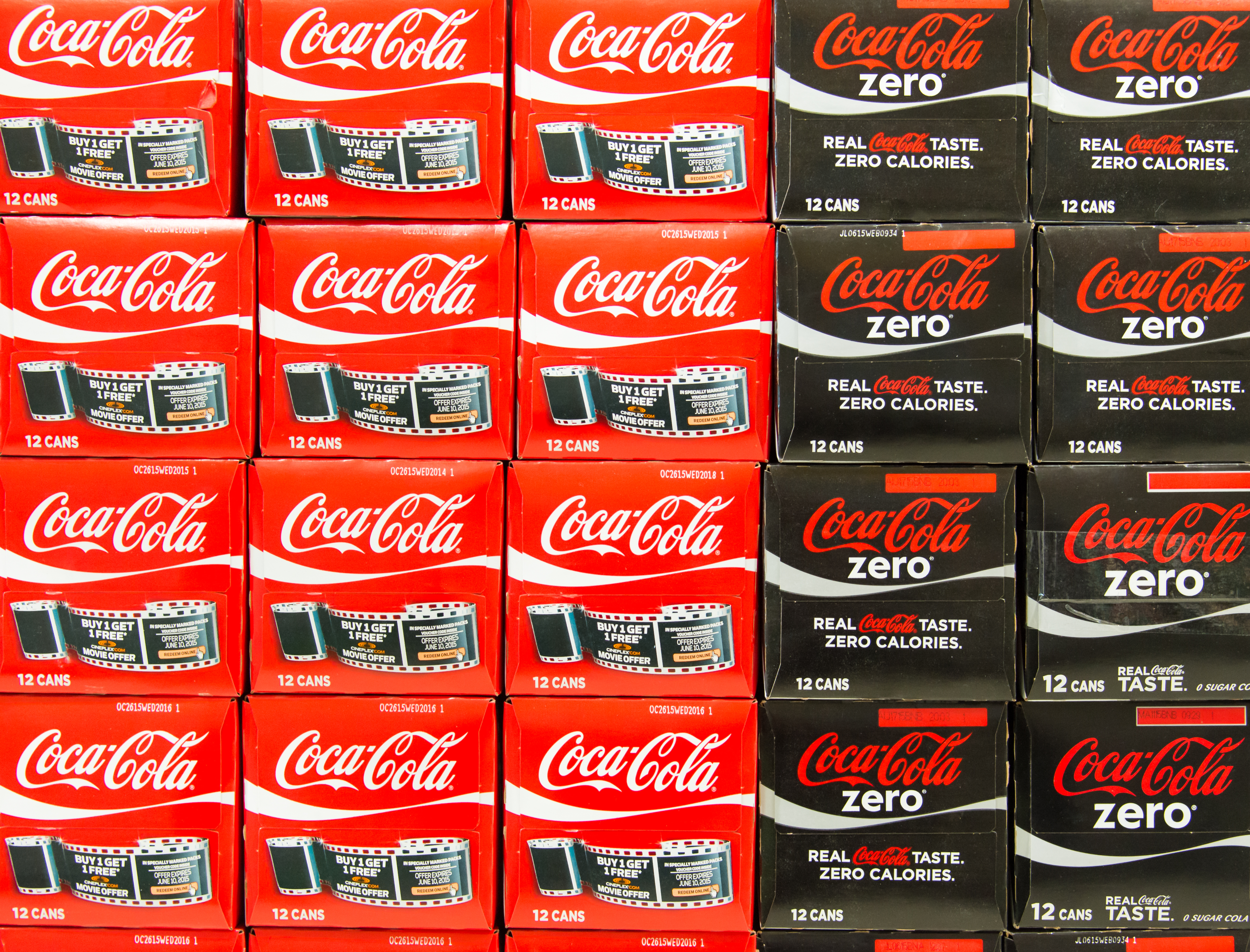 Pile of Coca Cola boxes in a grocery store. Coke has tried to recruit health experts to win health-minded Americans to their side.